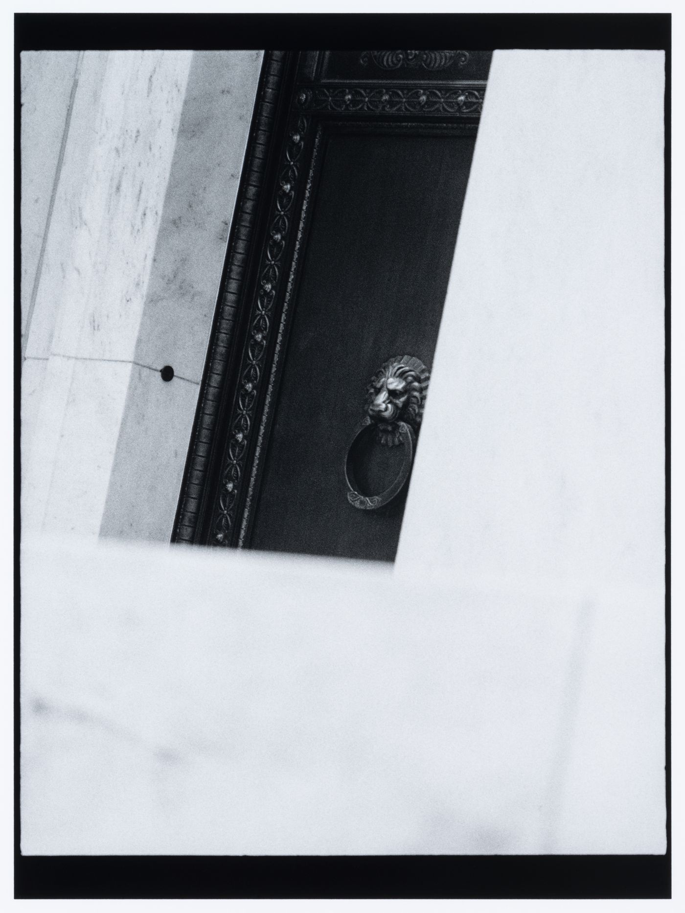 Partial view of a doorway and showing a door knocker in the shape of a lion, Marriner S. Eccles Federal Reserve Board Building, Washington D.C., United States, from the series "Empire"