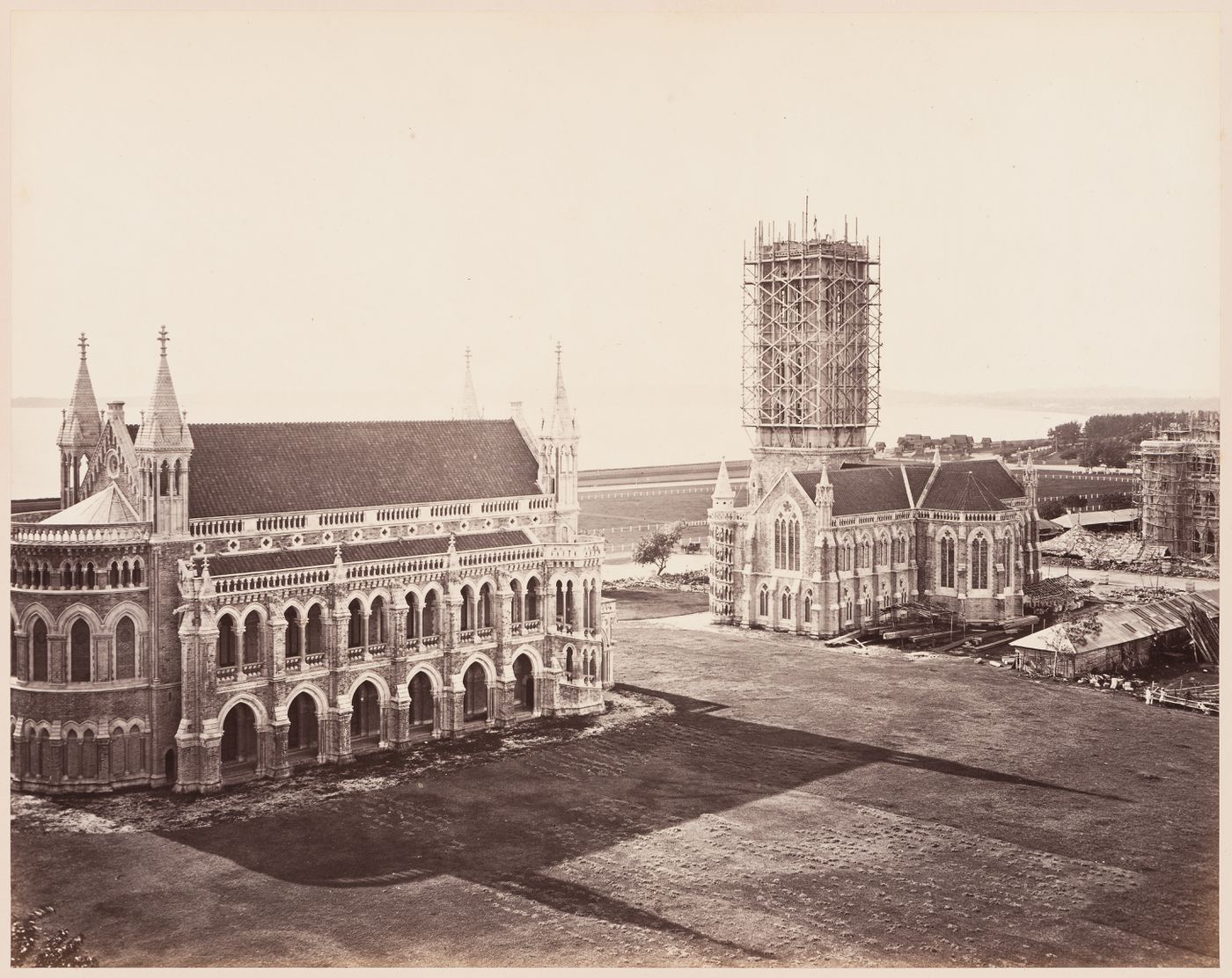 View of the Convocation Hall (also known as the University or Senate Hall) and the Library with the Rajabai Tower under construction, Bombay University (now Mumbai University), Mayo Road (now Bhaurao Patil Marg), Bombay (now Mumbai), India