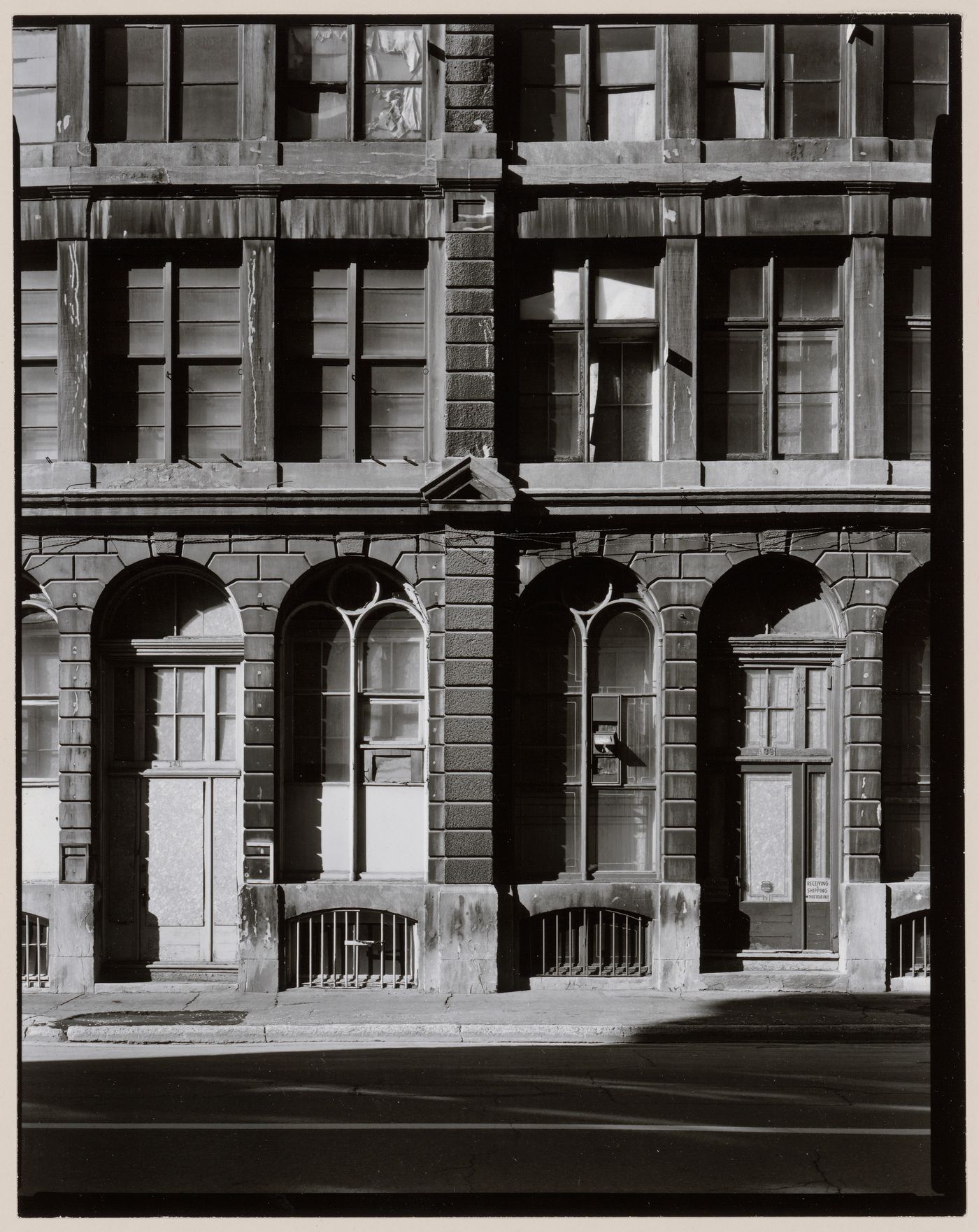 Partial view of warehouses showing windows and entrances, rue Saint-Pierre, Montréal, Québec