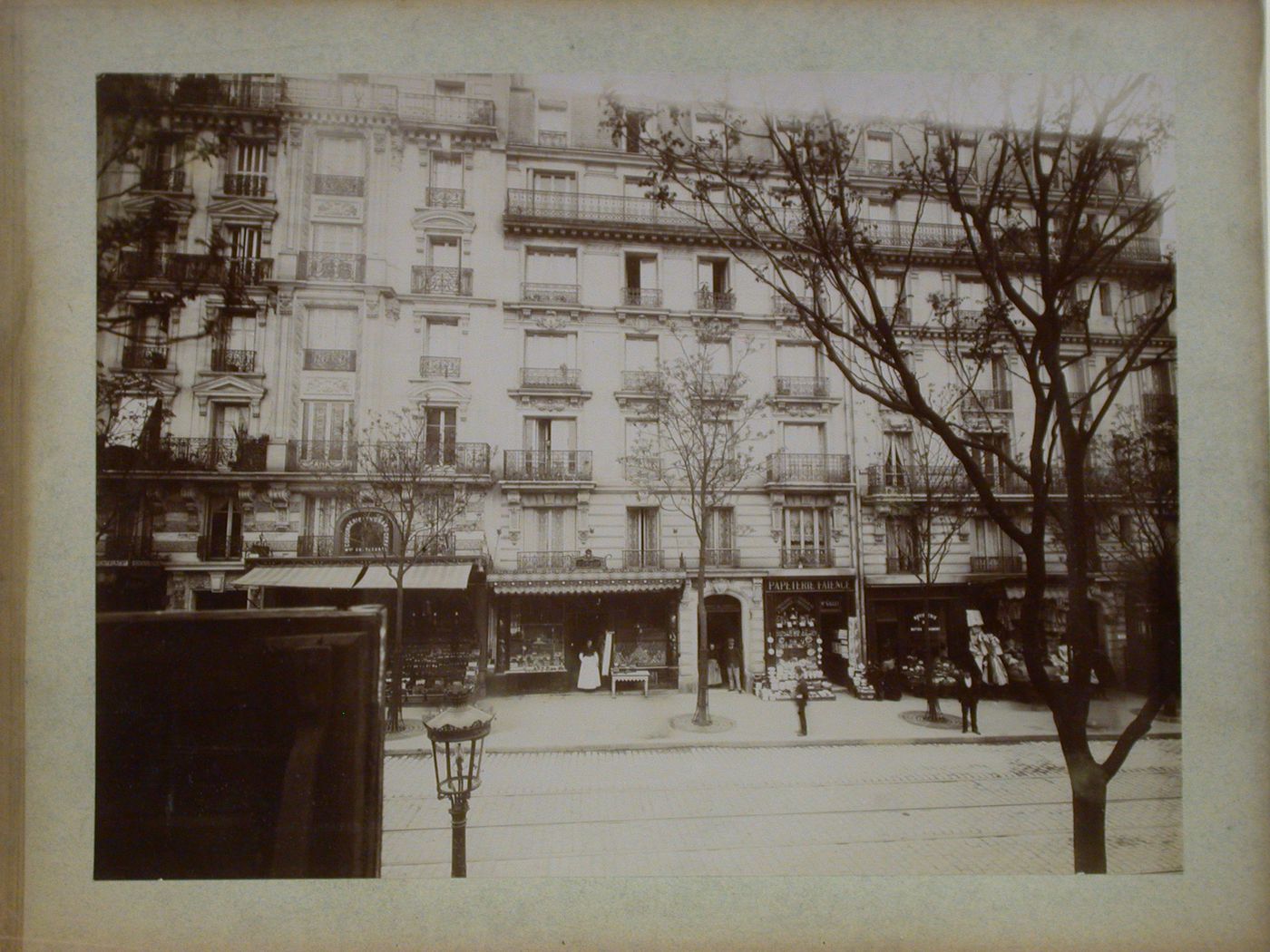 View across a street looking towards stores and apartment houses, Paris, France