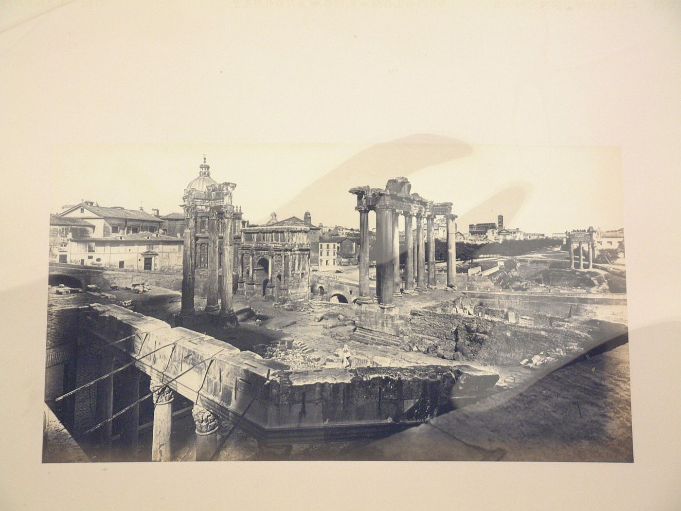 View of the Roman Forum showing the Tempio di Vespasiano, the Tempio di Saturno, the Arcus Septimii Severi, SS. Luca e Martina, and in the distance, the Colosseum, Rome, Italy