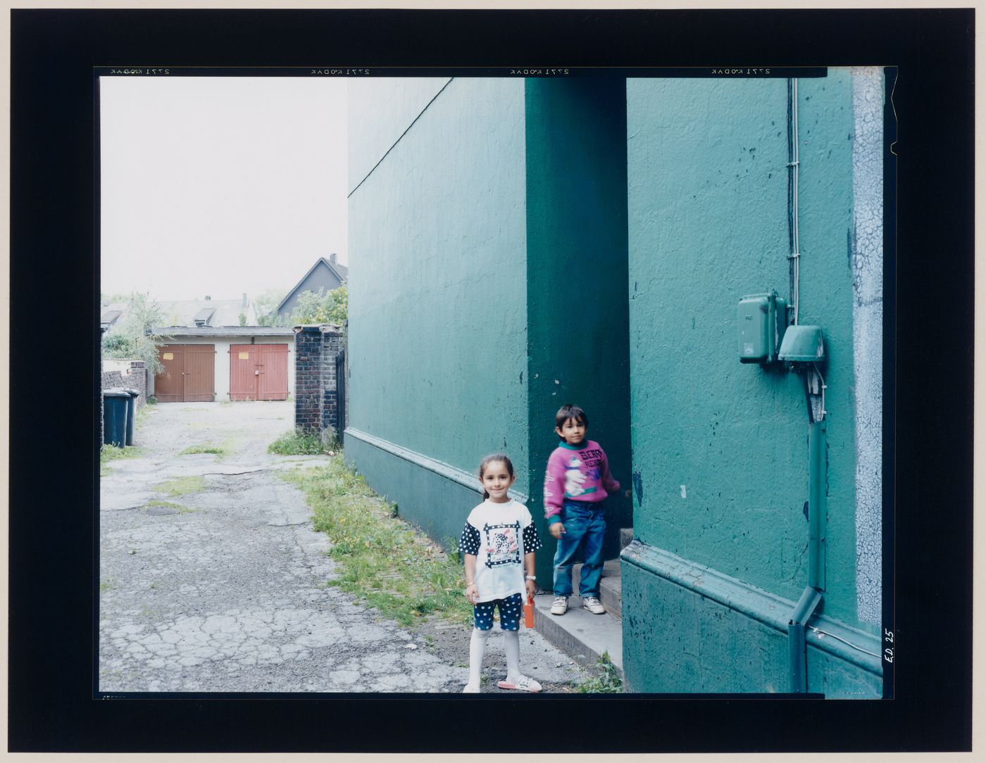 View of two children at the entrance to a garage, Germany (from the series "In between cities")