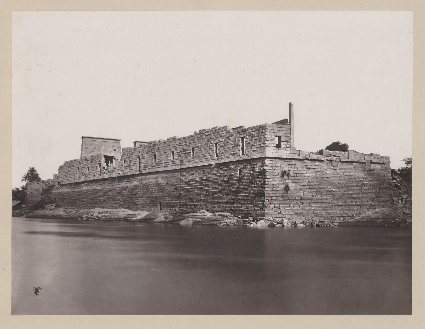 View from the south showing the southwest corner of the quai wall with First Pylon of the Temple of Isis on left, Philae, Egypt