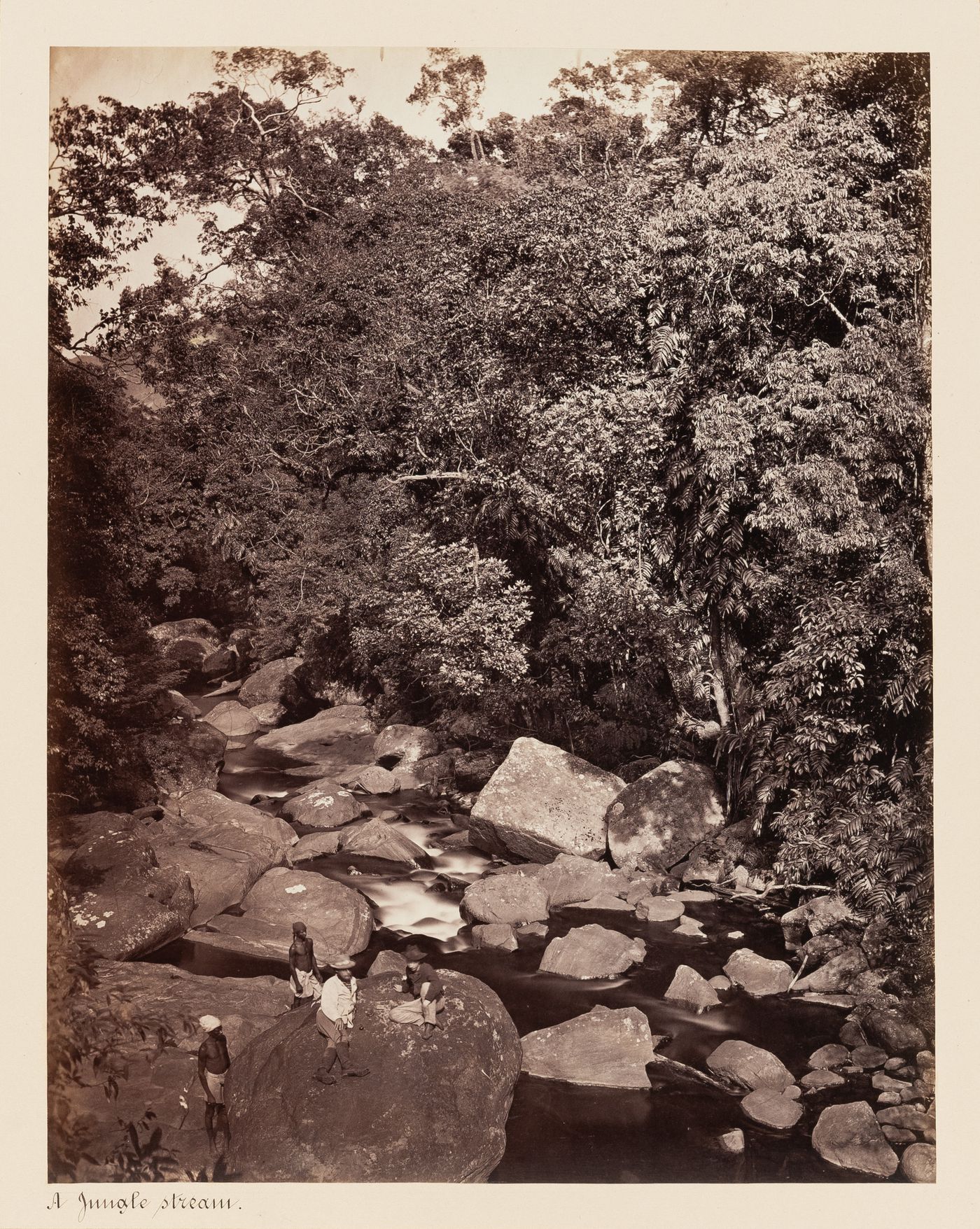 View of men beside a river, Ceylon (now Sri Lanka)