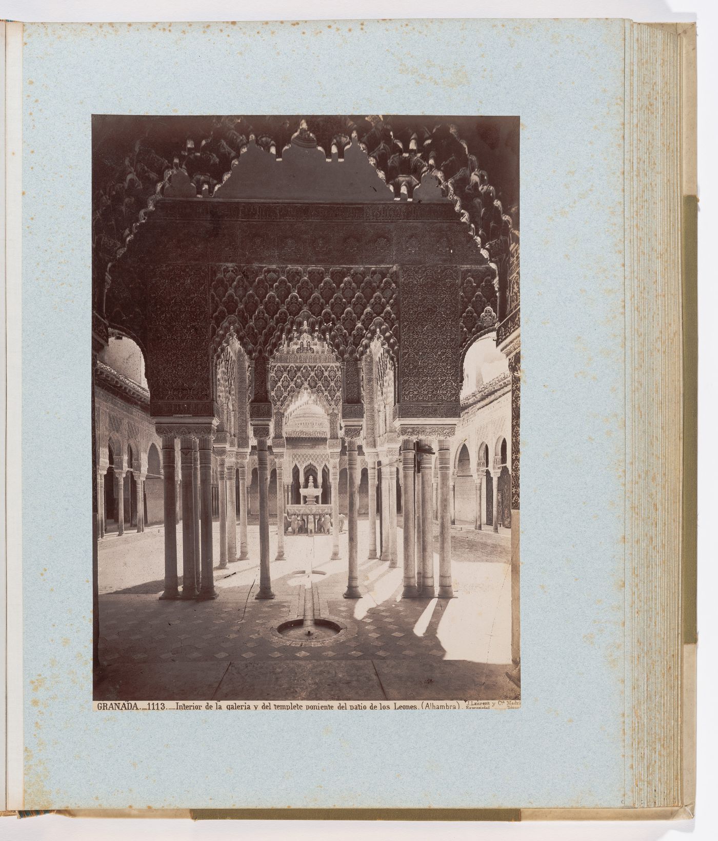 View of arches, pillars, and central fountain in Court of the Lions, from west pavilion, Alhambra, Granada, Spain
