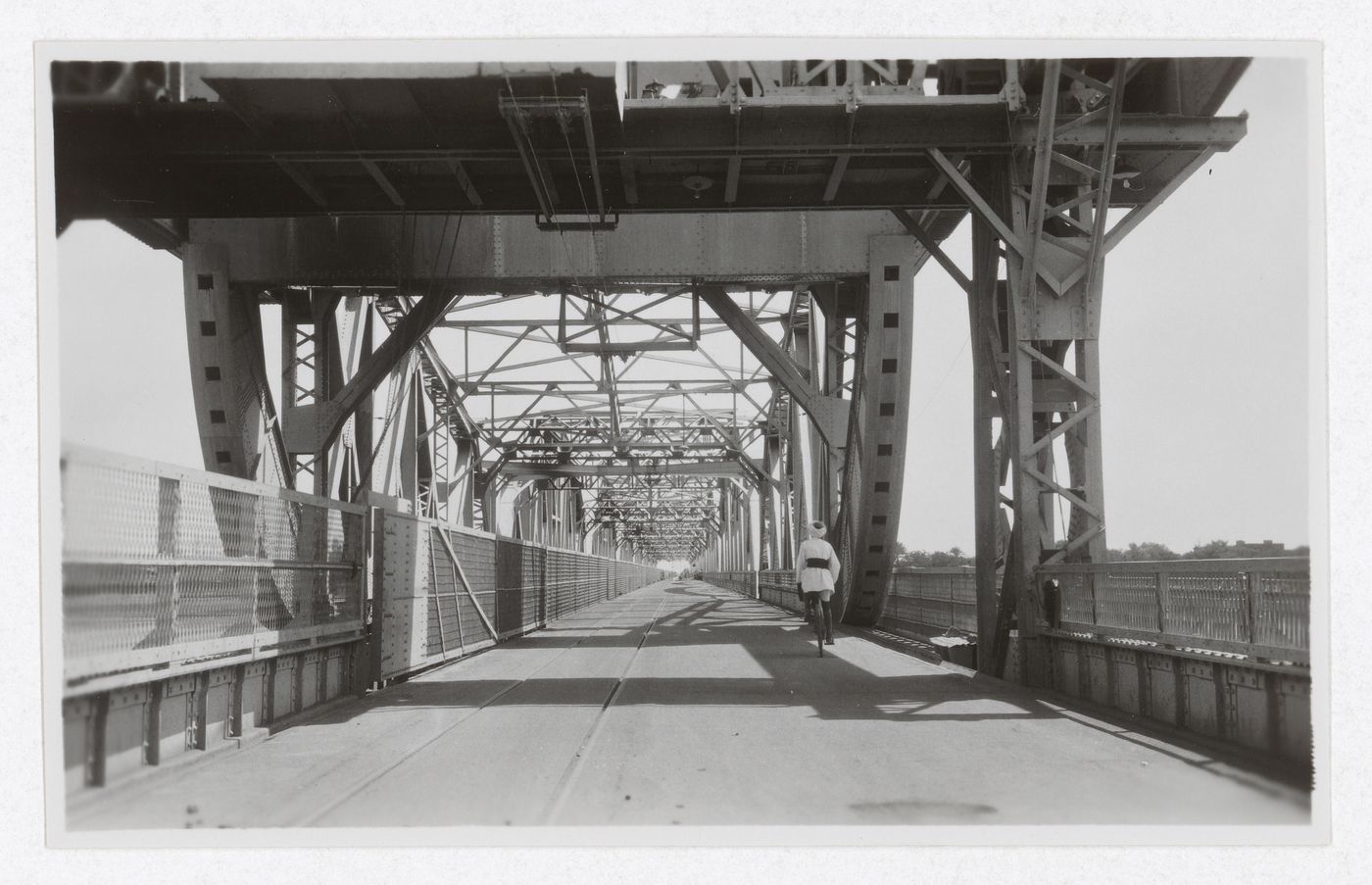 View of man riding a bicycle on the Blue Nile Road and Railway Bridge, Khartoum, Sudan