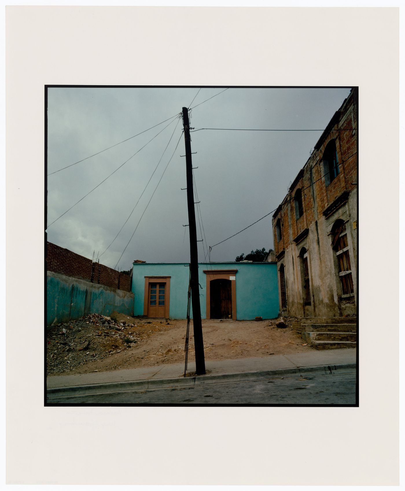 View of a utility pole with unidentified buildings in the background, Oaxaca, Mexico