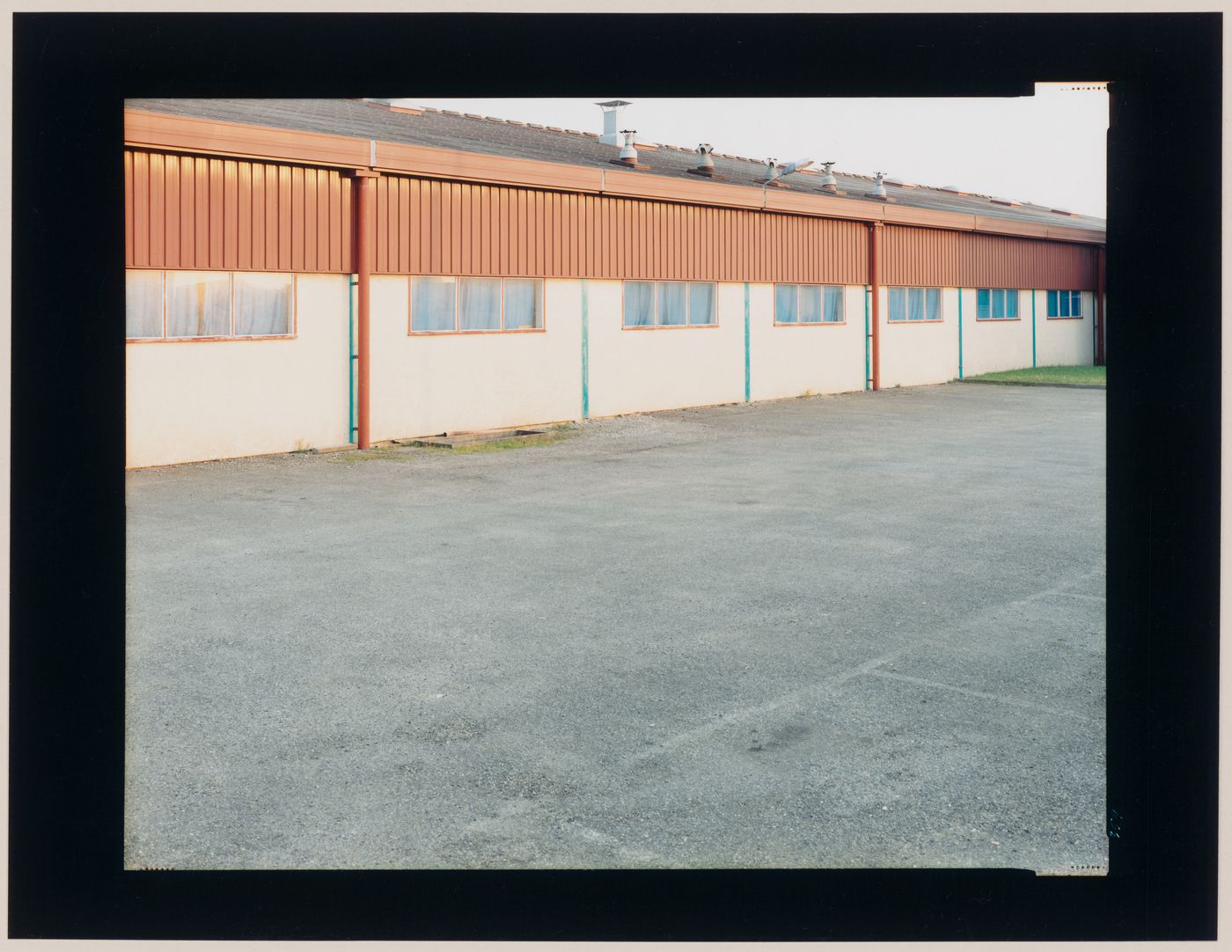 View of a building and a parking lot, Orthez, France (from the series "In between cities")