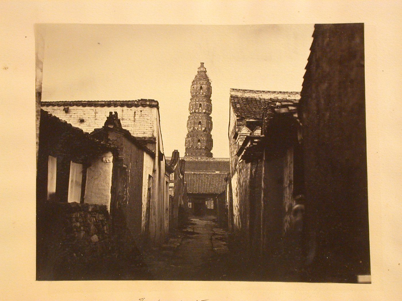 View of a street and the upper part of the Heaven Conferred Pagoda [Tianfeng Ta], Ningpo (now Ningbo), China