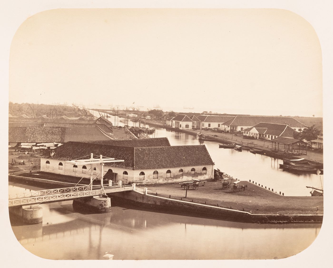 View of the Haven Kanaal [Harbour Canal] showing the Pasar Ikan [Fish Market], the Vierkantsbrug [Square Bridge] and several customhouses and port administration buildings, Batavia (now Jakarta), Dutch East Indies (now Indonesia)