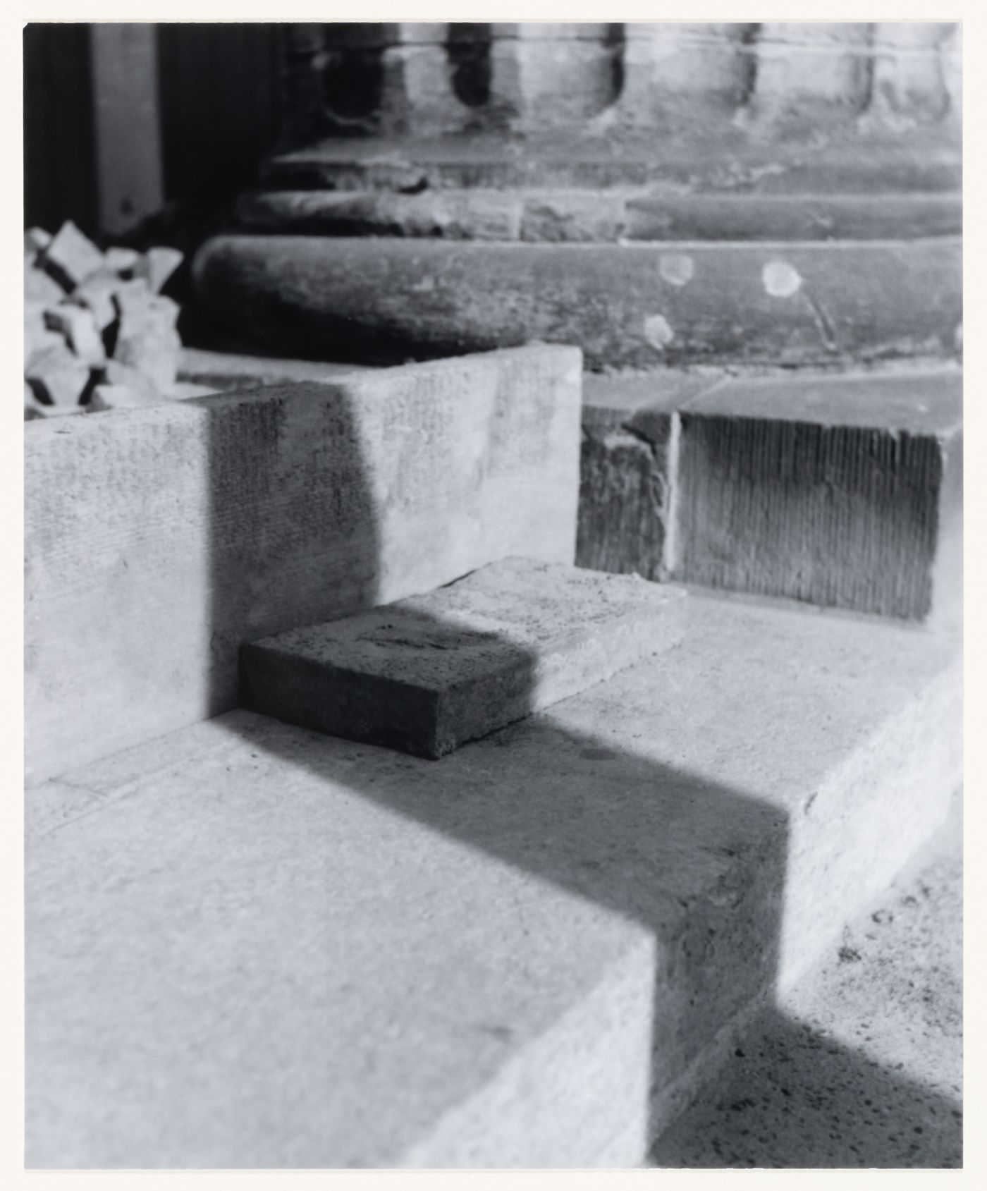 View of stones, building materials, a step, the base of a column and a cast shadow, Berlin, Germany, from the artist book "The Potsdamer Project"