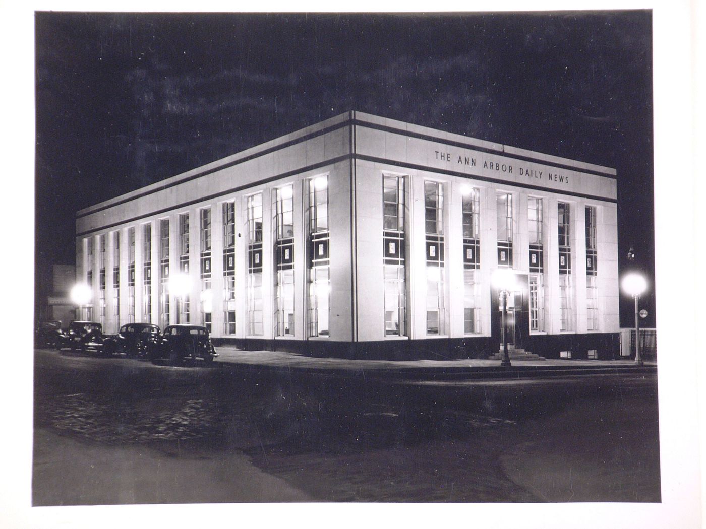 View of the principal and lateral façades of the Ann Arbour Daily News Building at night, Detroit, Michigan