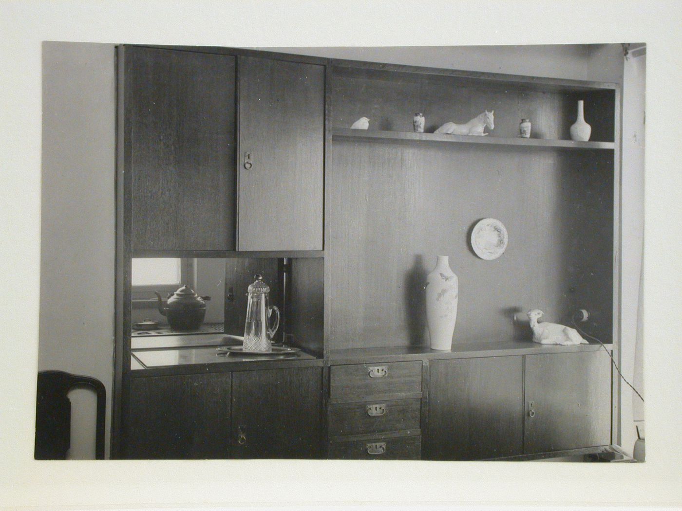 Interior view of Nikolai Milutin's apartment showing the built-in wall unit in the dining room [?] which opens onto the built-in kitchen, People's Commissariat for Finance (Narkomfin) Apartment Building, 25 Novinskii Boulevard, Moscow