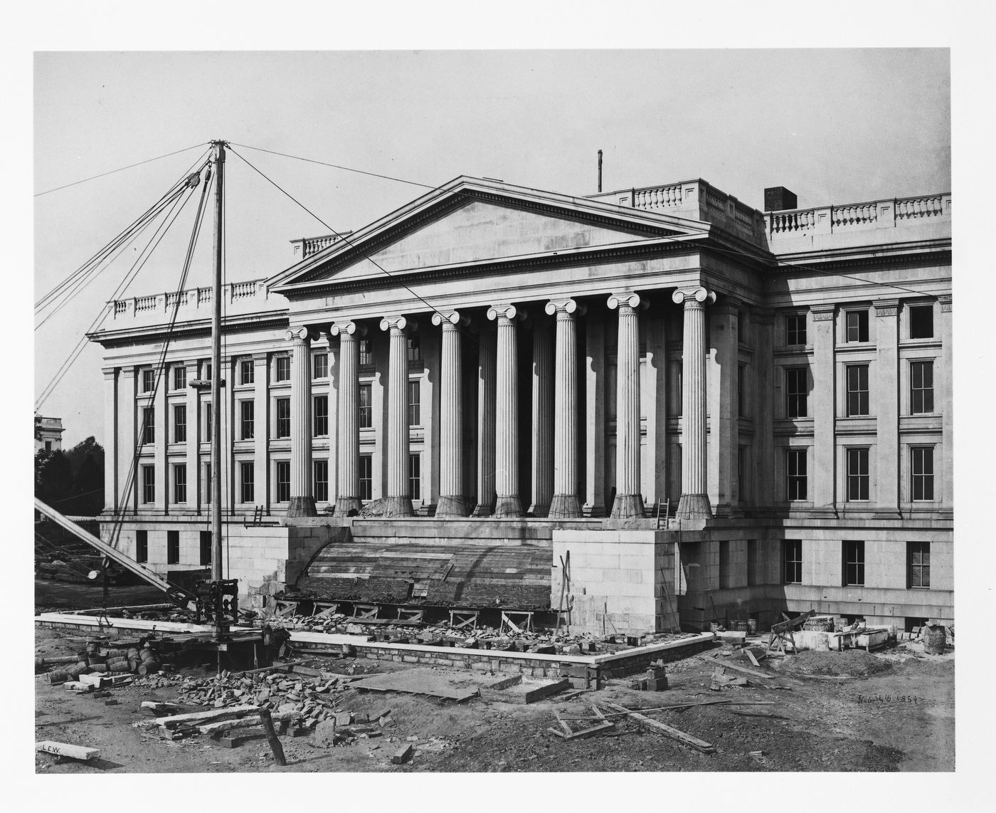 Treasury Building under contruction: Crane out front, front steps being built, Washington, District of Columbia