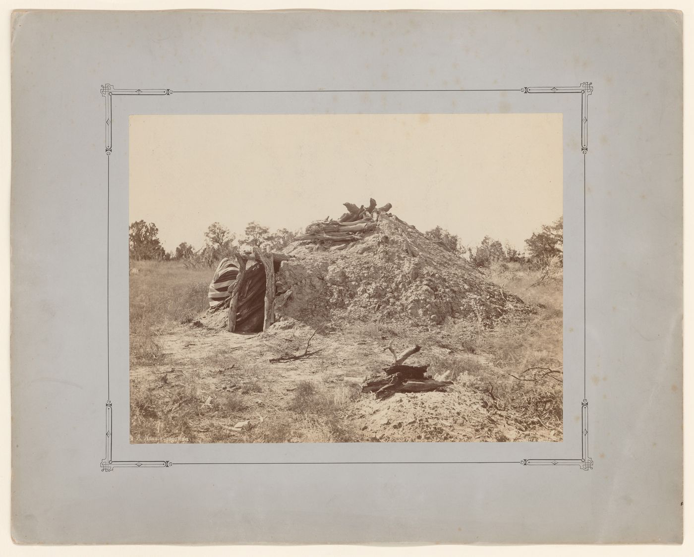 View of a Navajo conical forked-pole hogan with earth cover, Navajo, New Mexico