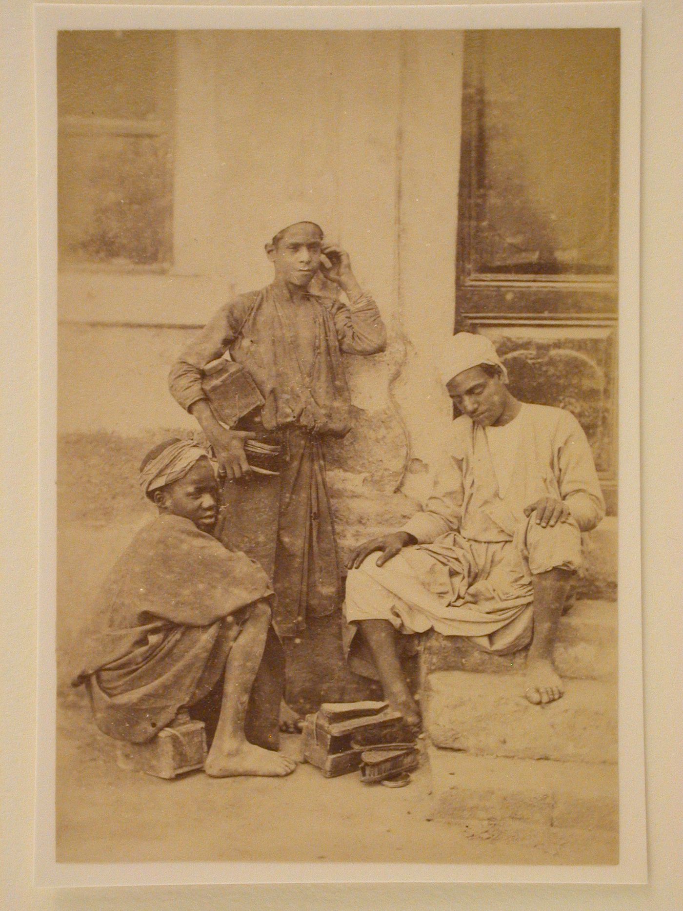 Group of three Egyptian shoe shine boys