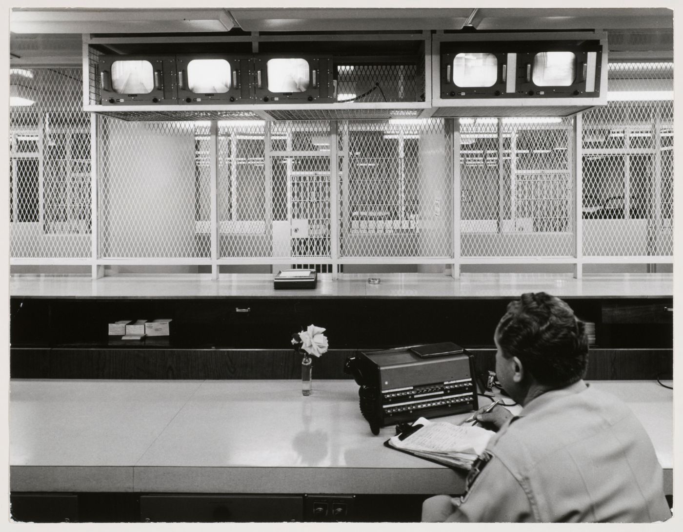 Interior view of the jailer's desk with a seated man seen from the back, Clark County Courthouse building, Las Vegas, Nevada, United States