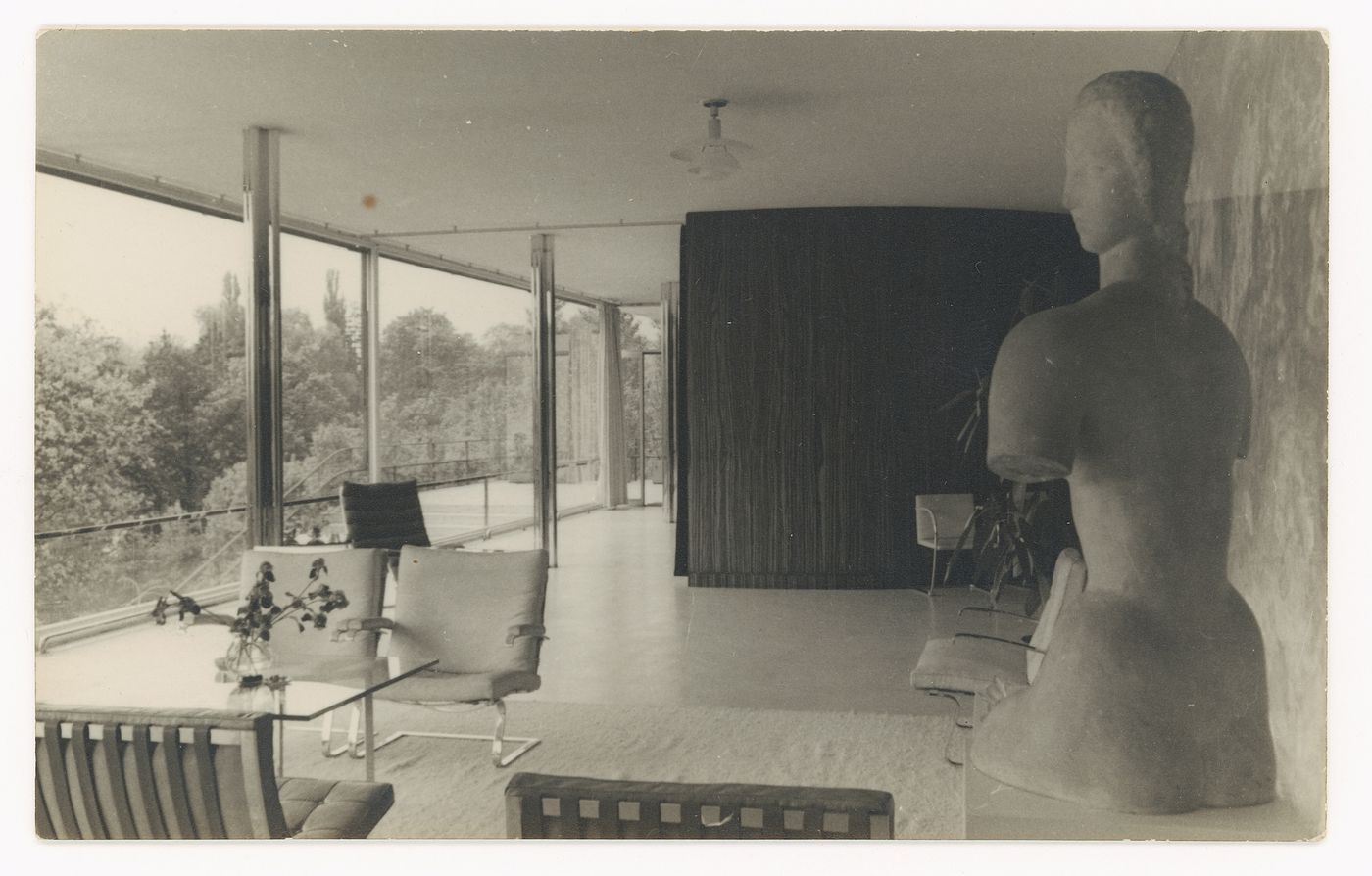 Interior view of the living area looking west showing a seating area on the left and a statue on the right, Tugendhat House, Brno, Czechoslovakia (now Czech Republic)