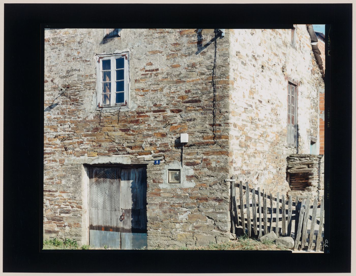 View of a stone house showing a door, windows and a fence, Castrotierra de Valmadrigal, León Province, Spain (from the series "In between cities")