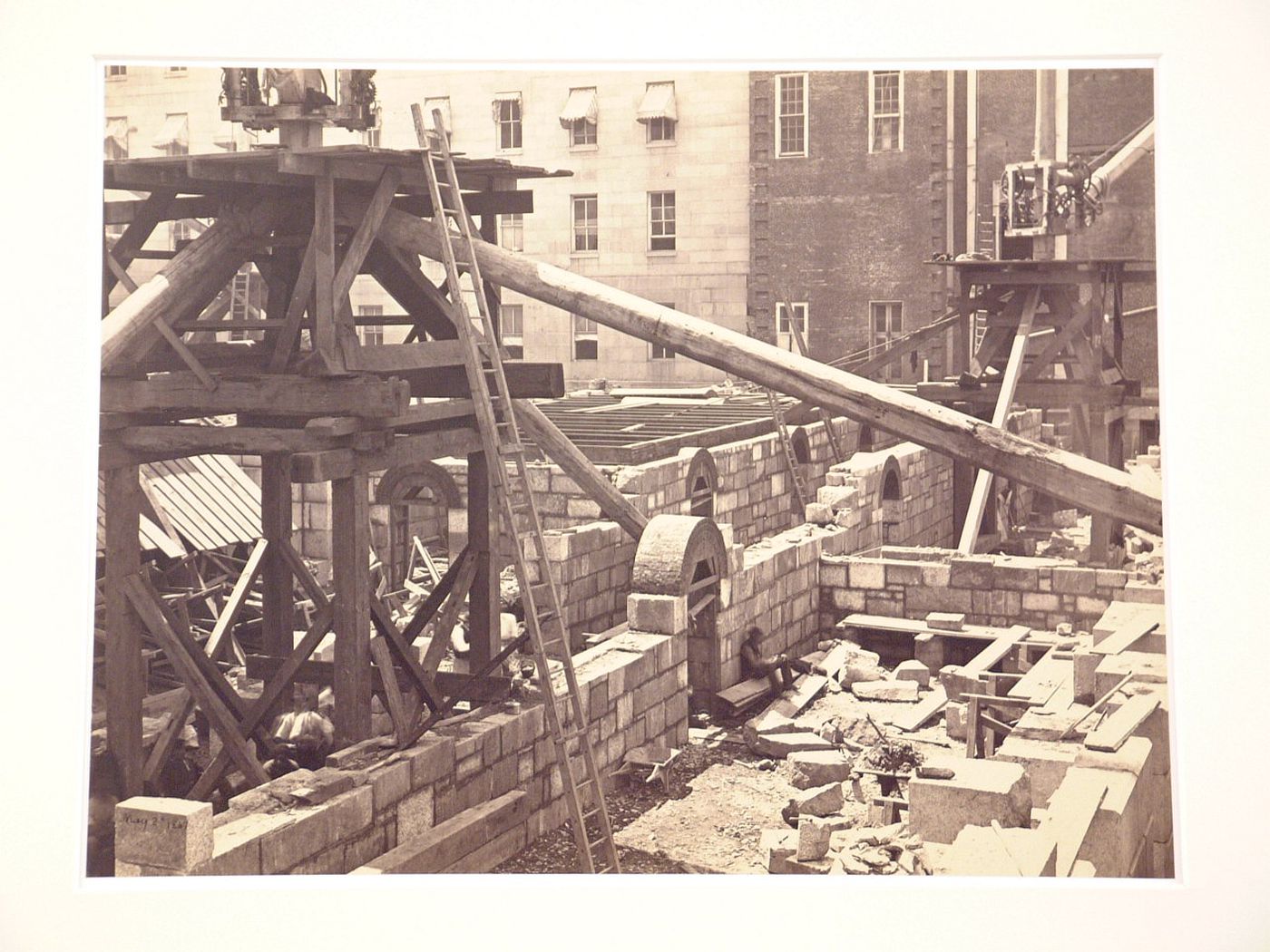 Treasury Building under contruction: Looking down on lower level with figures and cranes on scaffolds, Washington, District of Columbia