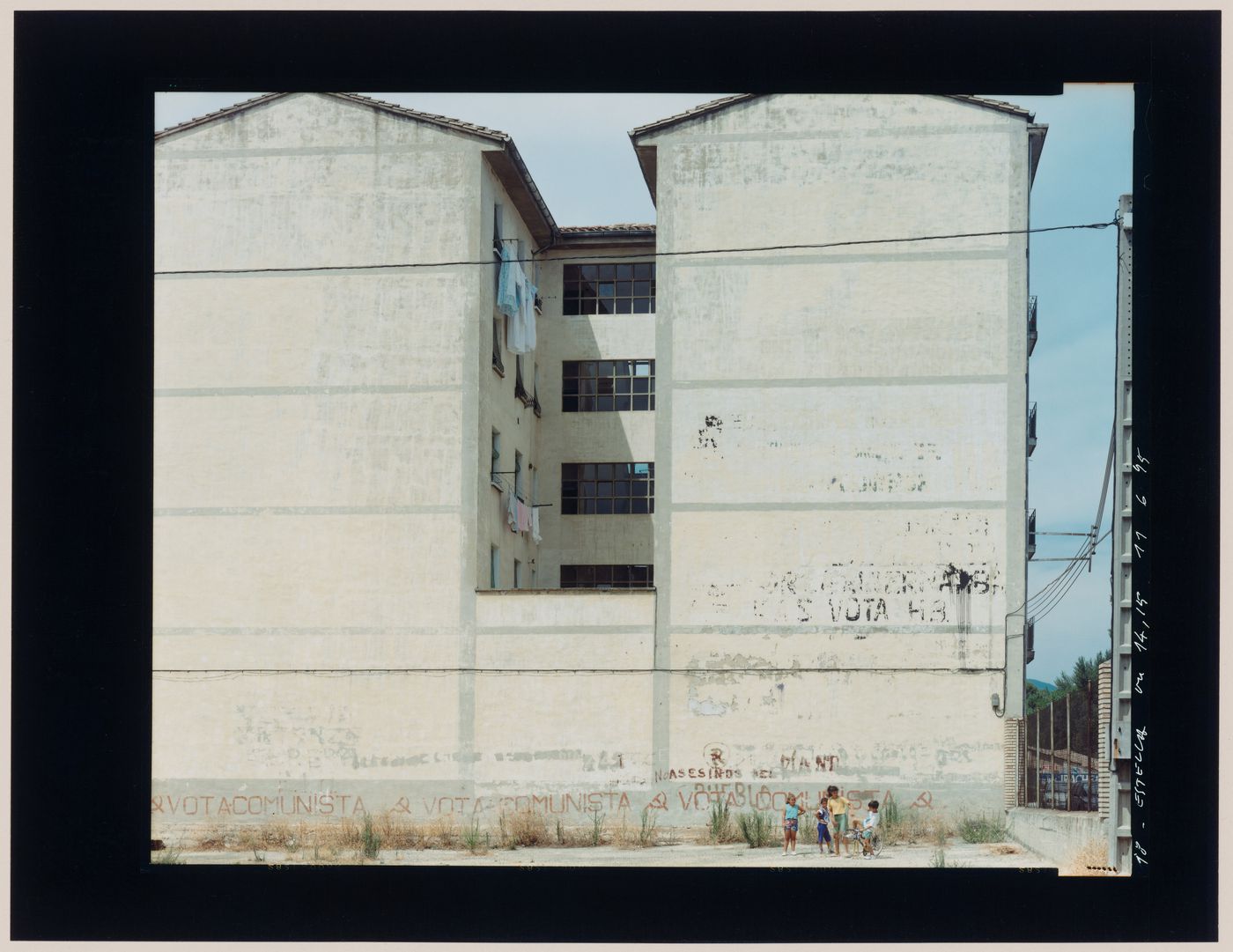 View of an apartment house showing children and a wall with graffiti, Estella, Spain (from the series "In between cities")