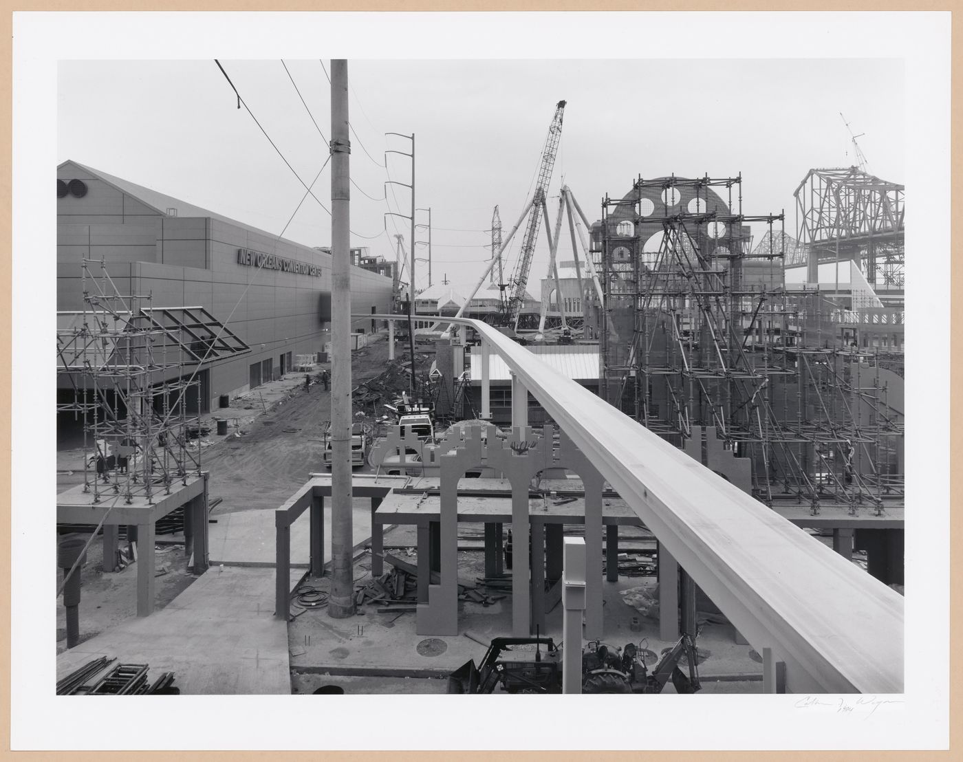 View of the Wonderwall under construction and Monorail track with New Orleans Convention Center (now George Moscone Convention Center) on the left, Louisiana World Exposition, New Orleans, United States