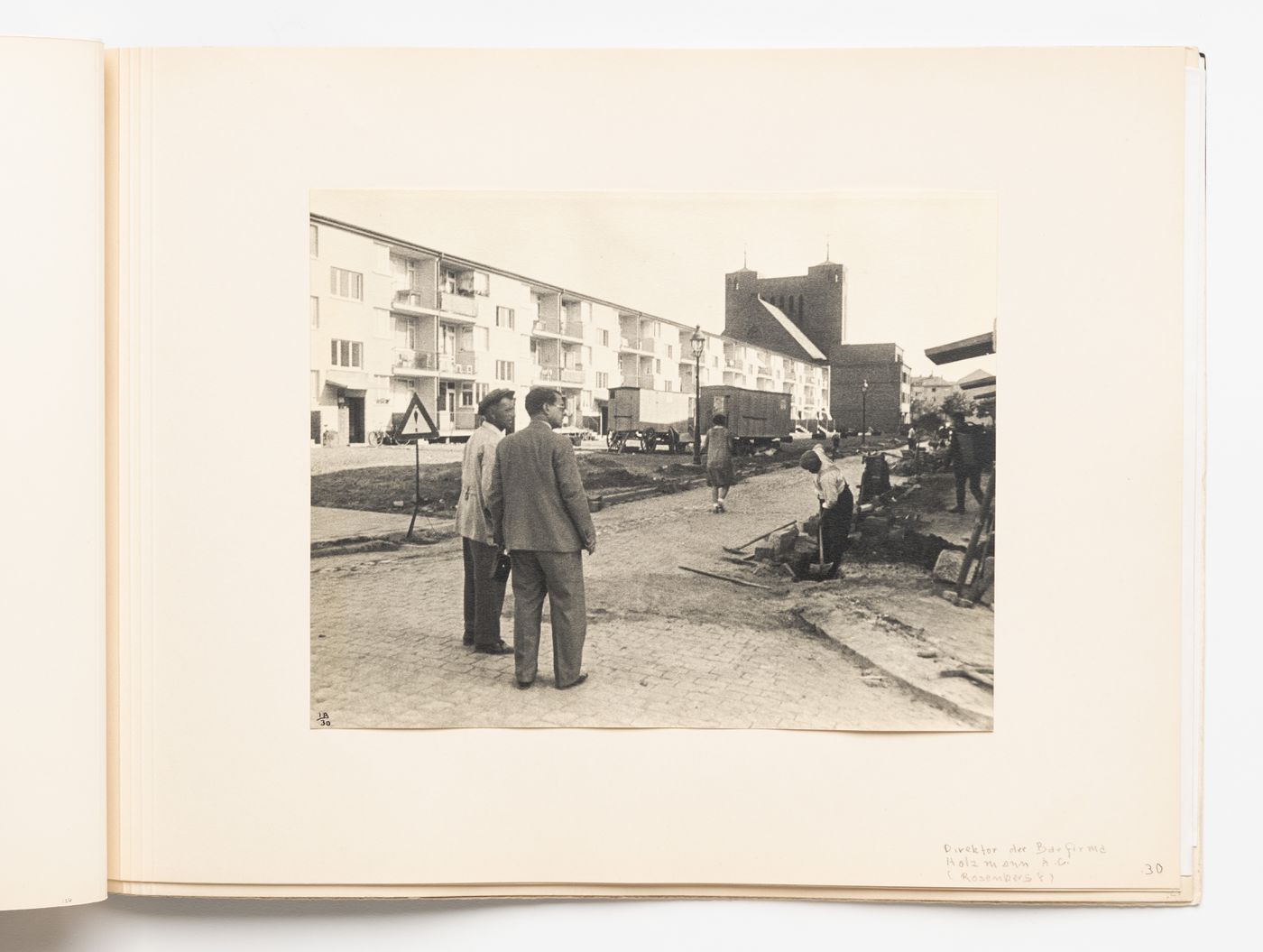 Exterior view of type A housing units with the Director of Holzmann A.G., Mr. Rosenberg [?], and a foreman [?], Hellerhof Housing Estate, Frankfurt am Main, Germany