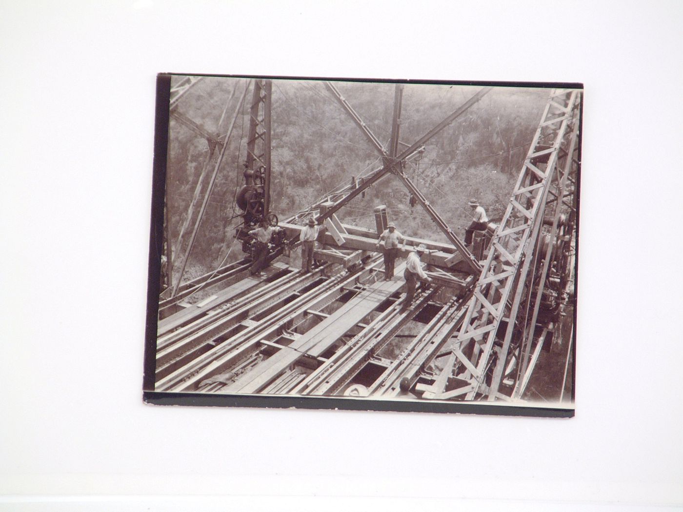 View of five people standing on bridge during the construction of Victoria Falls Bridge, Zambezi River, crossing the border between Victoria Falls, Zimbabwe and Livingstone, Zambia