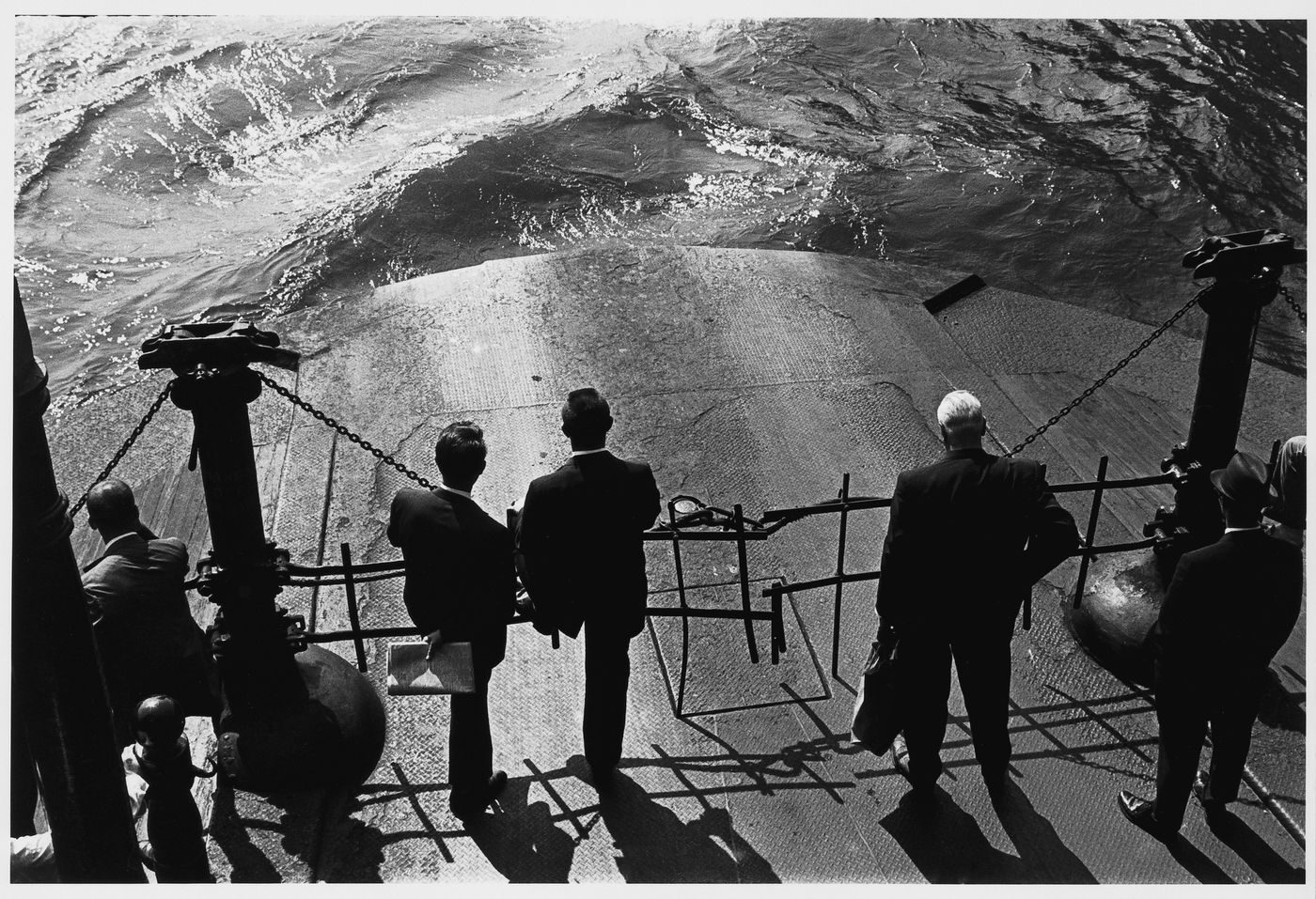 View of men standing on the deck of the Hoboken Ferry looking at the water