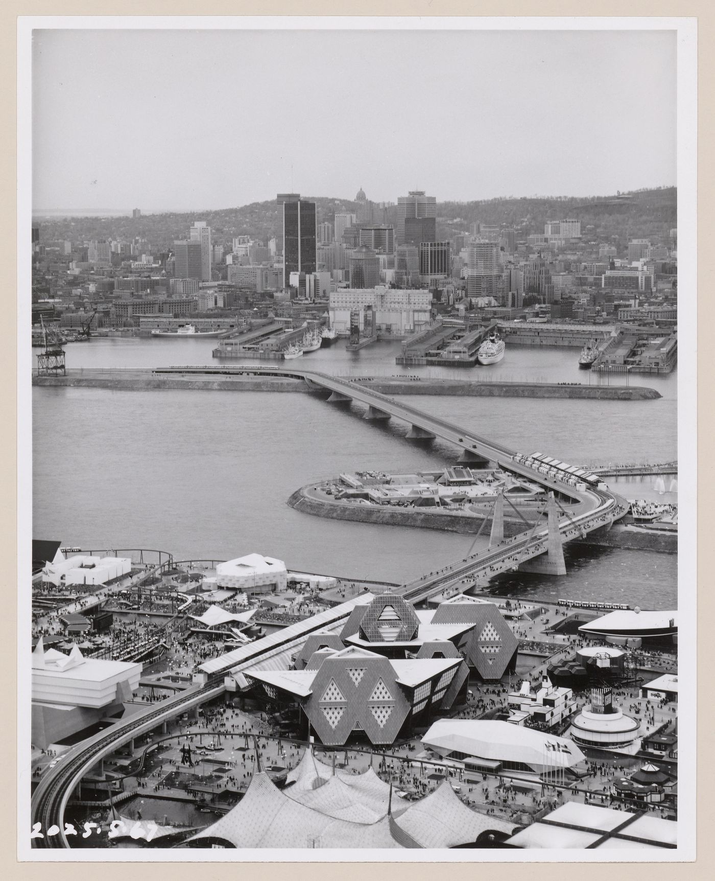 Aerial view of the Île Notre-Dame site, the port and of Montréal downtown, Expo 67, Montréal, Québec