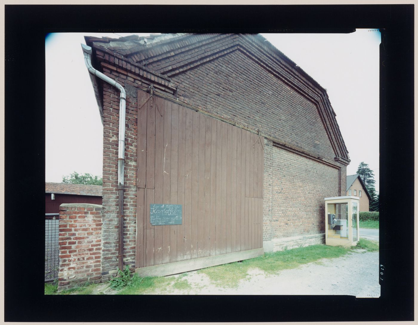 View of a brick building and a phone booth, Germany