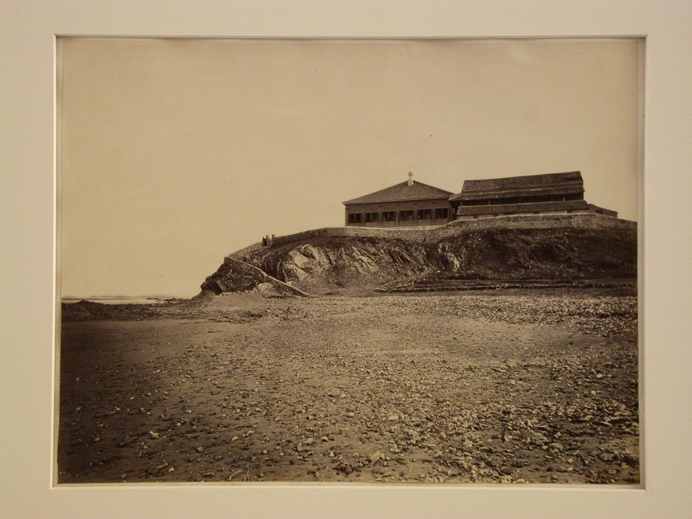 View of a villa [?] and stone wall on a promontory, near Yent'ai (also formerly known as Chefoo, now Yantai), Shantung (now Shandong Sheng), China