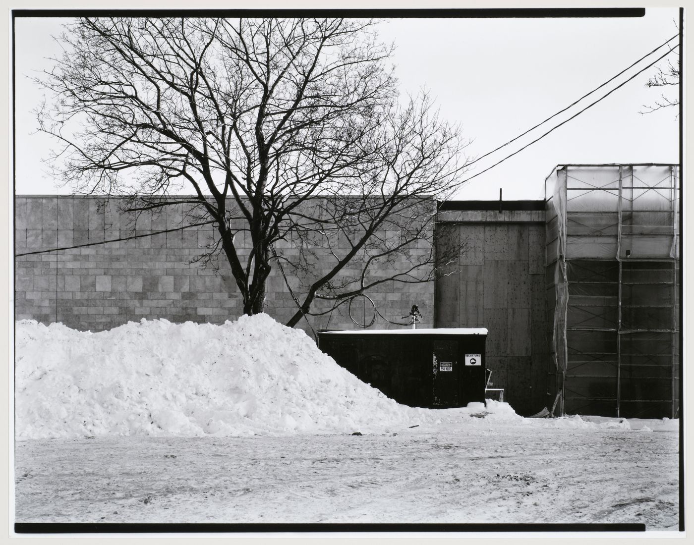 Partial view of the principal façade showing an electric substation and scaffolds, Canadian Centre for Architecture under construction, Montréal, Québec