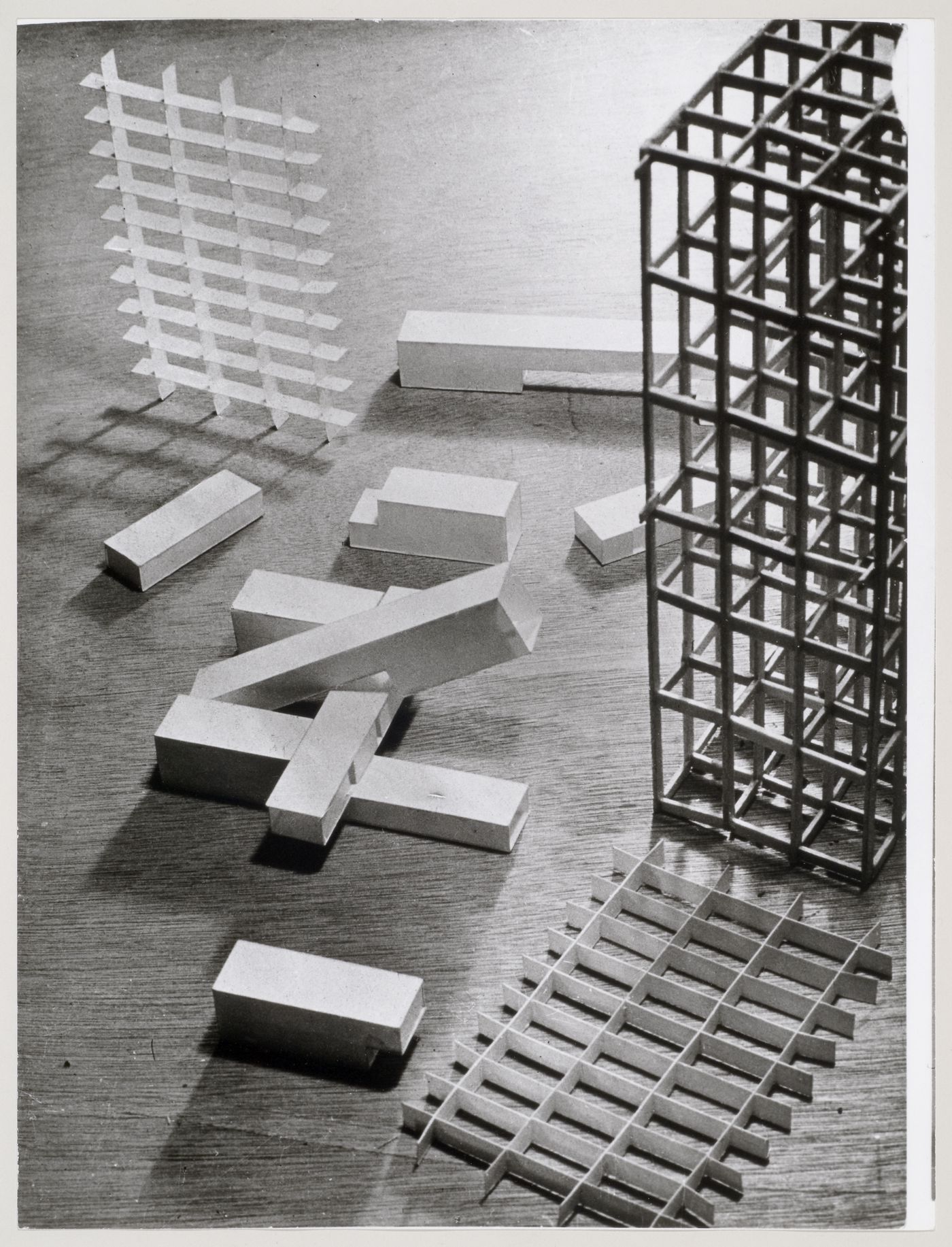 View of unassembled elements of a study model for Unité d'habitation showing the corner of the main wooden structural grid, a cardboard grid representing the loggias, and several cardboard tubes, possibly elevator and ventilation shafts, Marseille, France