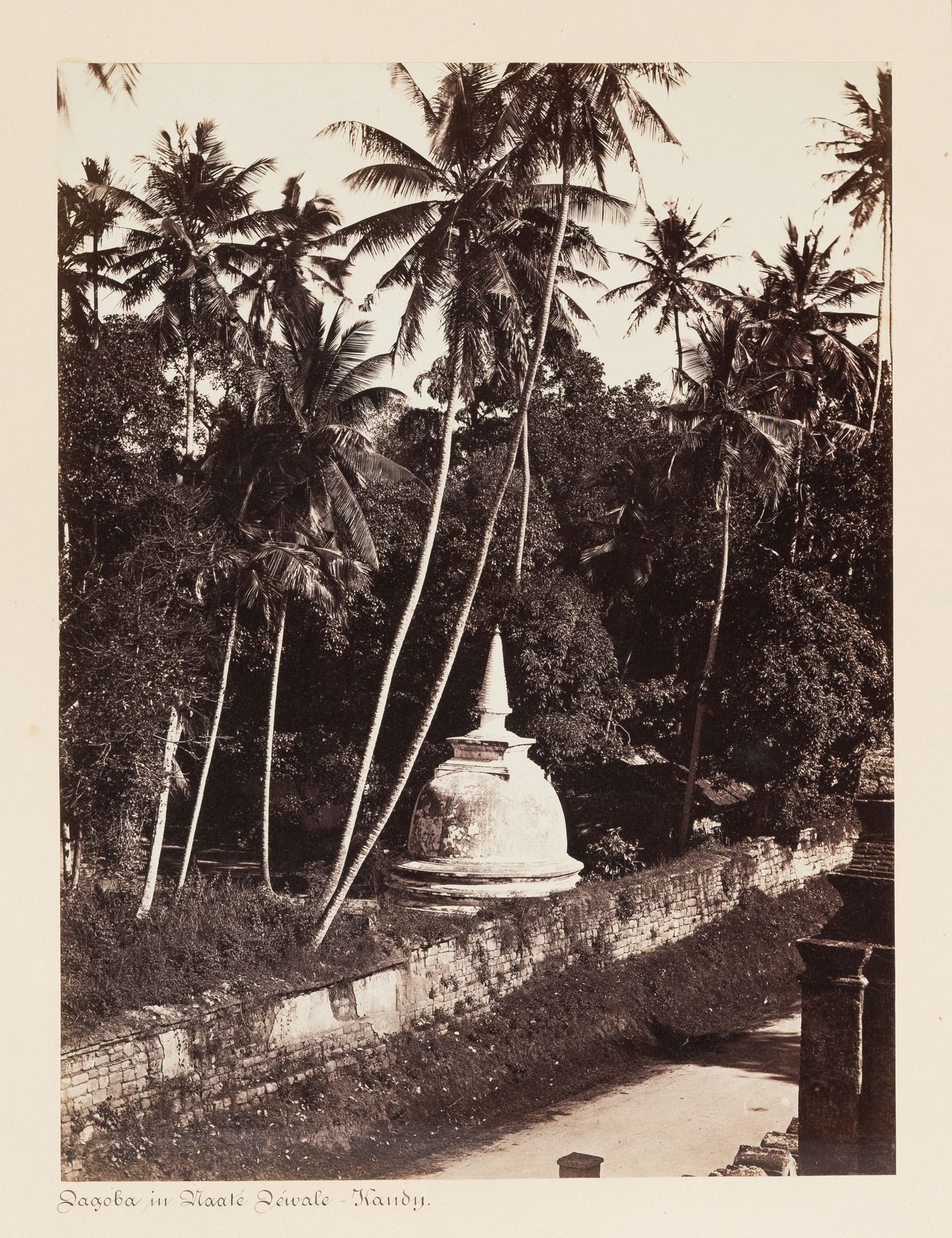 View of a dagoba, beside the Temple of the Tooth (also known as the Sri Dalada Maligawa), Kandy, Ceylon (now Sri Lanka)
