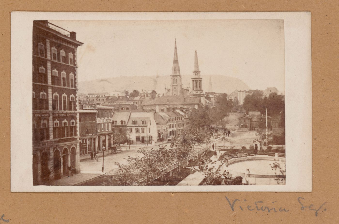 Partial view of Victoria Square showing the fountain, stores, the old YMCA Headquarters on the left and Mount Royal in the background, Montréal, Canada (now Montréal, Québec, Canada)