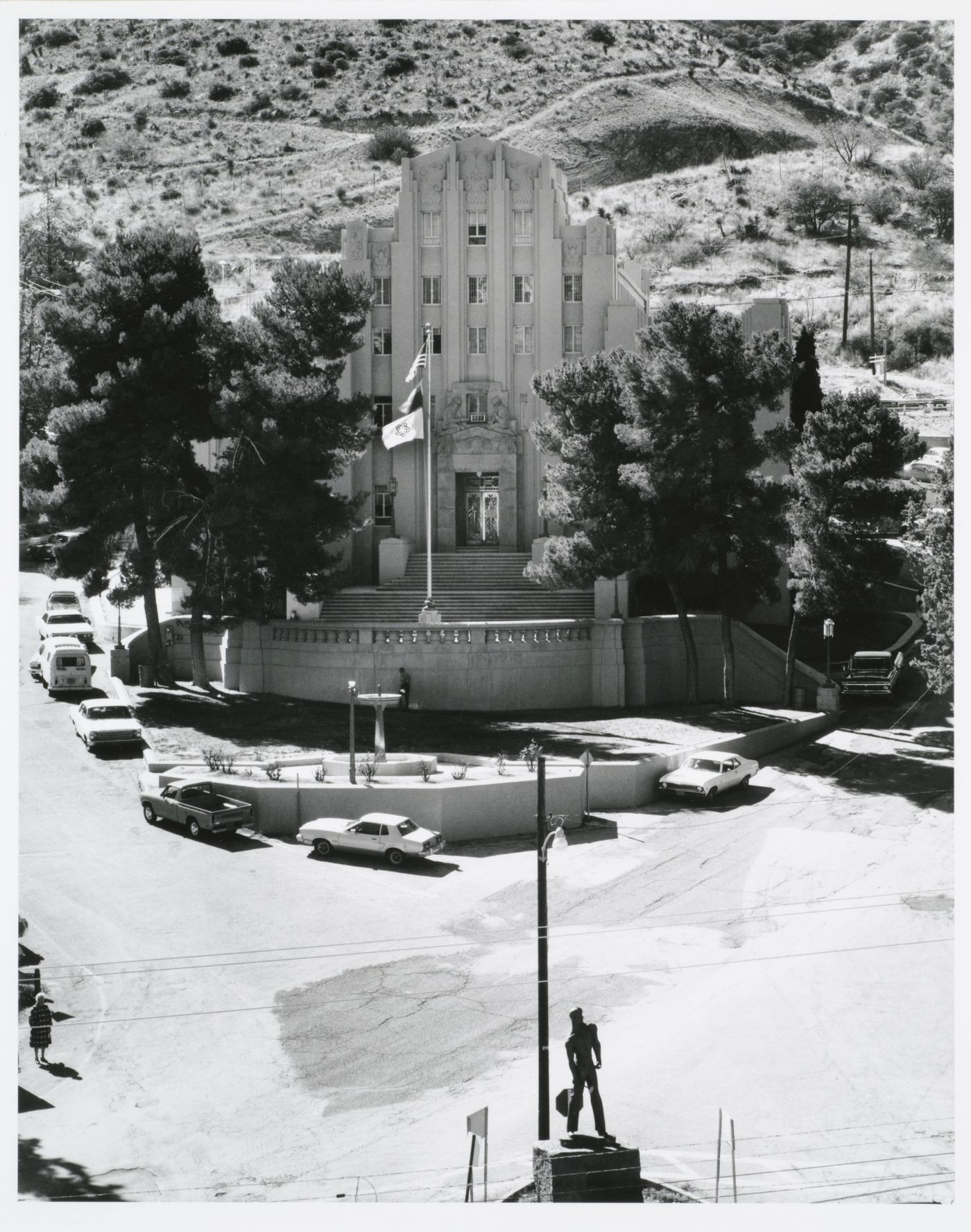 View of the Cochise County Courthouse showing a fountain and the Copper Miner Statue (also known as the Iron Man Statue) in the foreground, Tombstone Canyon Boulevard and Quality Hill Street, Bisbee, Arizona, United States