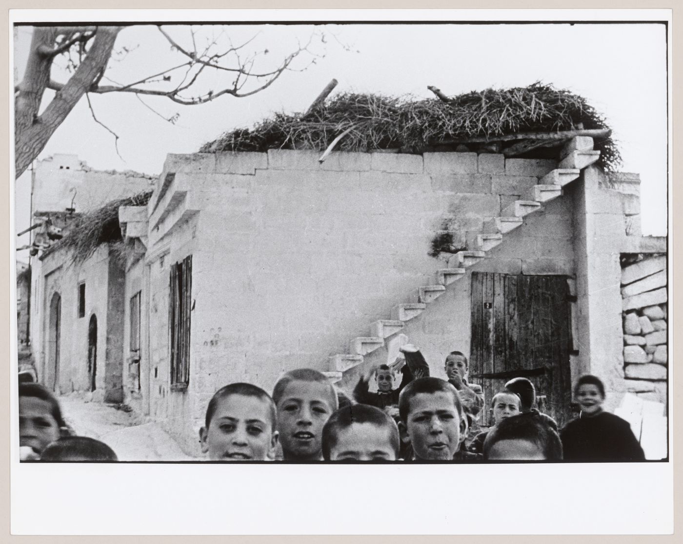 View of houses showing stairs and thatching with children in the foreground, Ürgüp, Cappadocia, Turkey