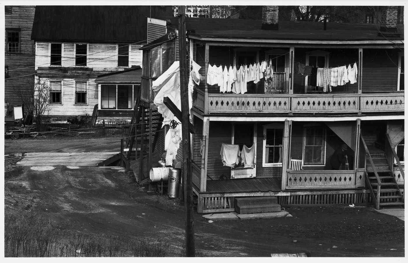 View of the rear façade of a house showing clothes hung on a clothes line with another house in the background, New Jersey