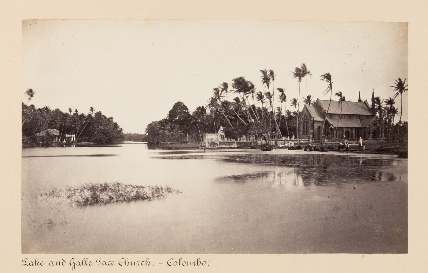 View of a lake with Galle Face Church (also known as Christ Church) on the right, Galle Face, Colombo, Ceylon (now Sri Lanka)