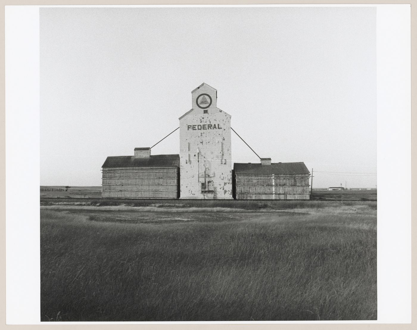 View of a grain elevator and two warehouses, New Dayton, Alberta