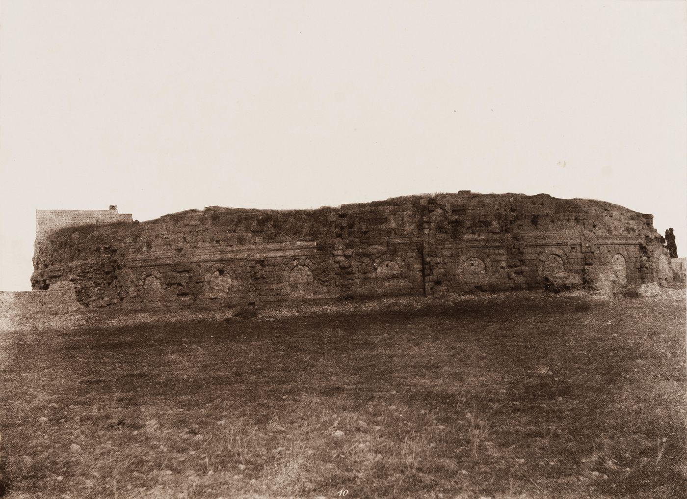 View of the ruins of the exterior wall of a Roman amphitheater, Jebel ed Druz, Ottoman Empire (now in Syria)