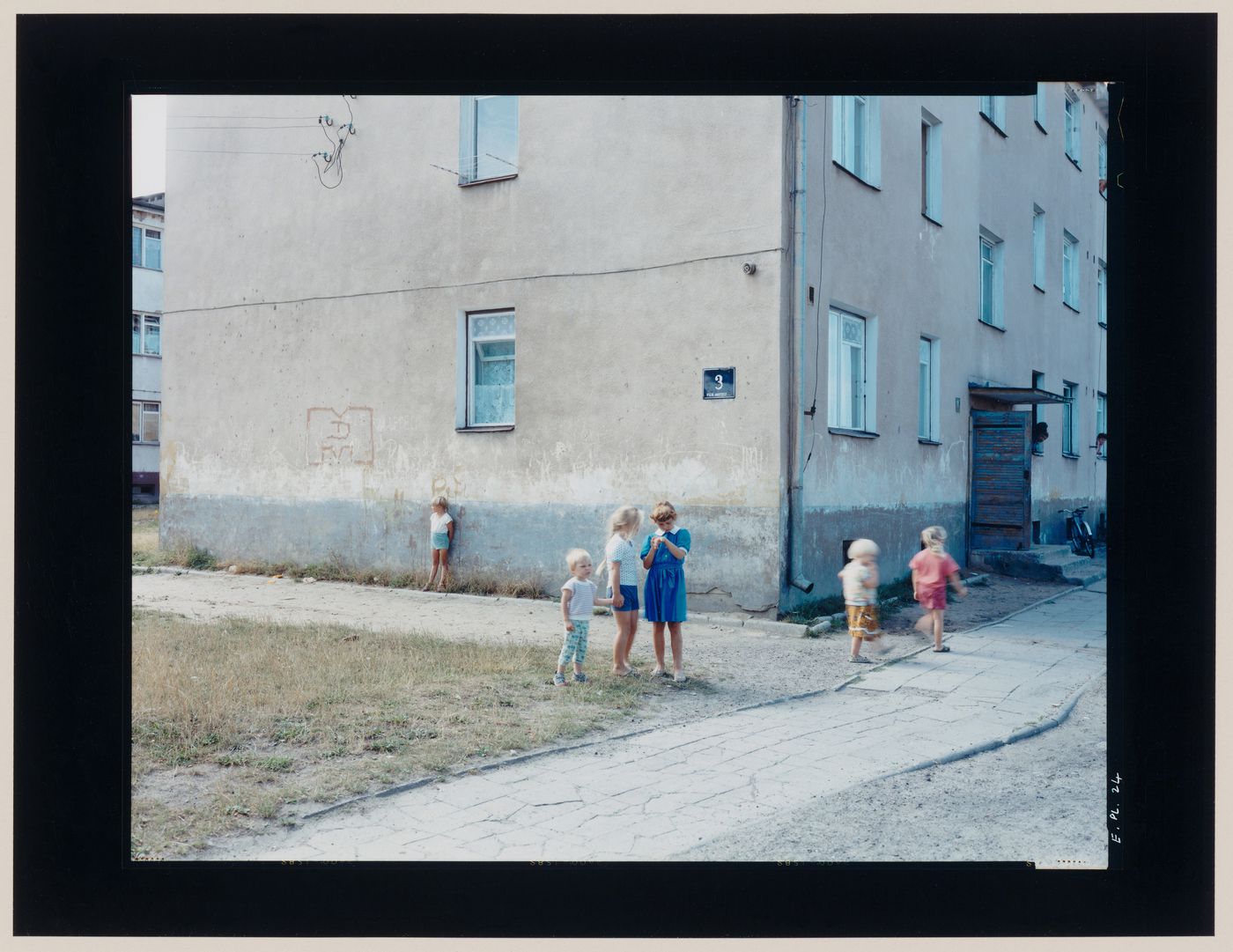 View of an apartment house and children, Gronowo, near Braniewo, Poland (from the series "In between cities")