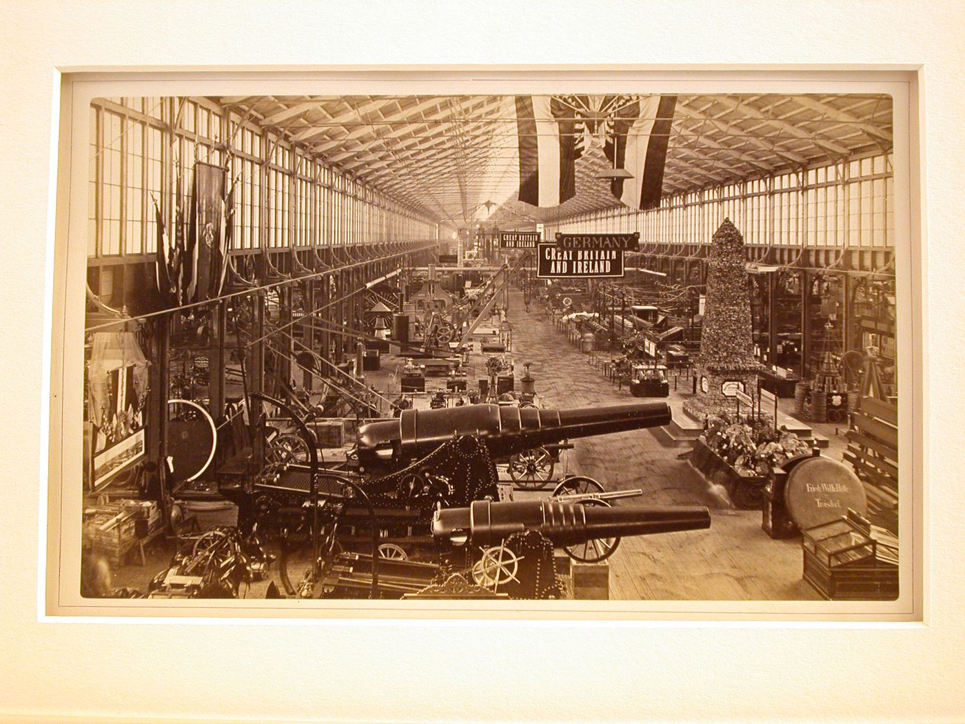 Interior view of Centennial International Exhibition of 1876, showing exhibits of canons, Germany, Great Britain and Ireland, Philadelphia, Pennsylvania, United States