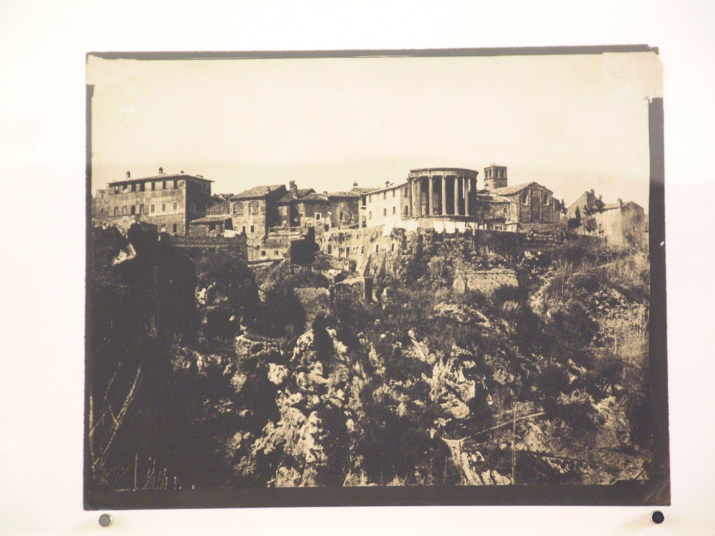 View of temple of Vesta and town on hill, Tivoli, Italy