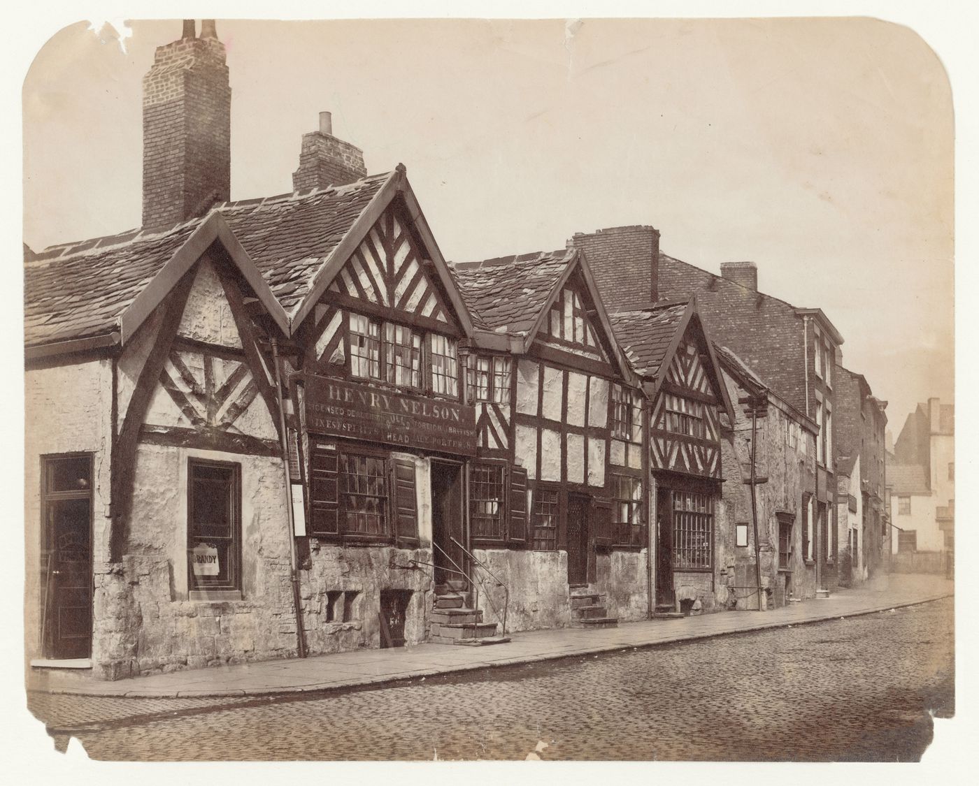 View of a street of small shops and houses, Manchester, England