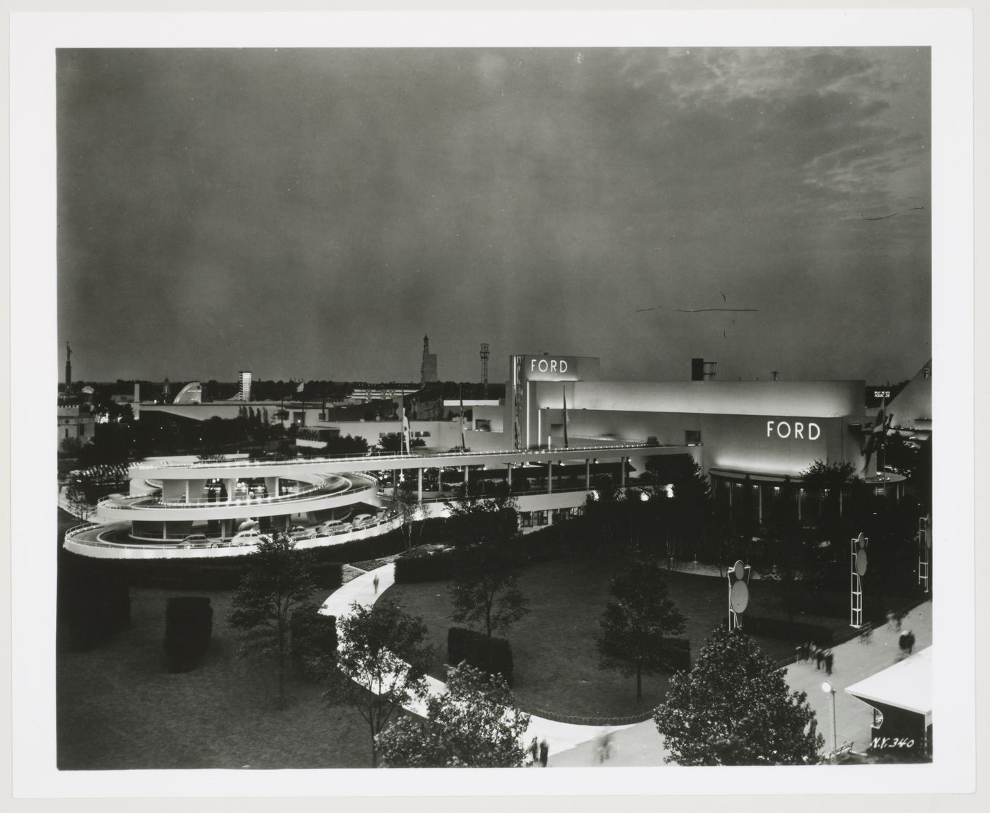 View of the Ford Motor Company pavilion at night showing a ramp and automobiles, 1939-1940 New York World's Fair, New York City, New York