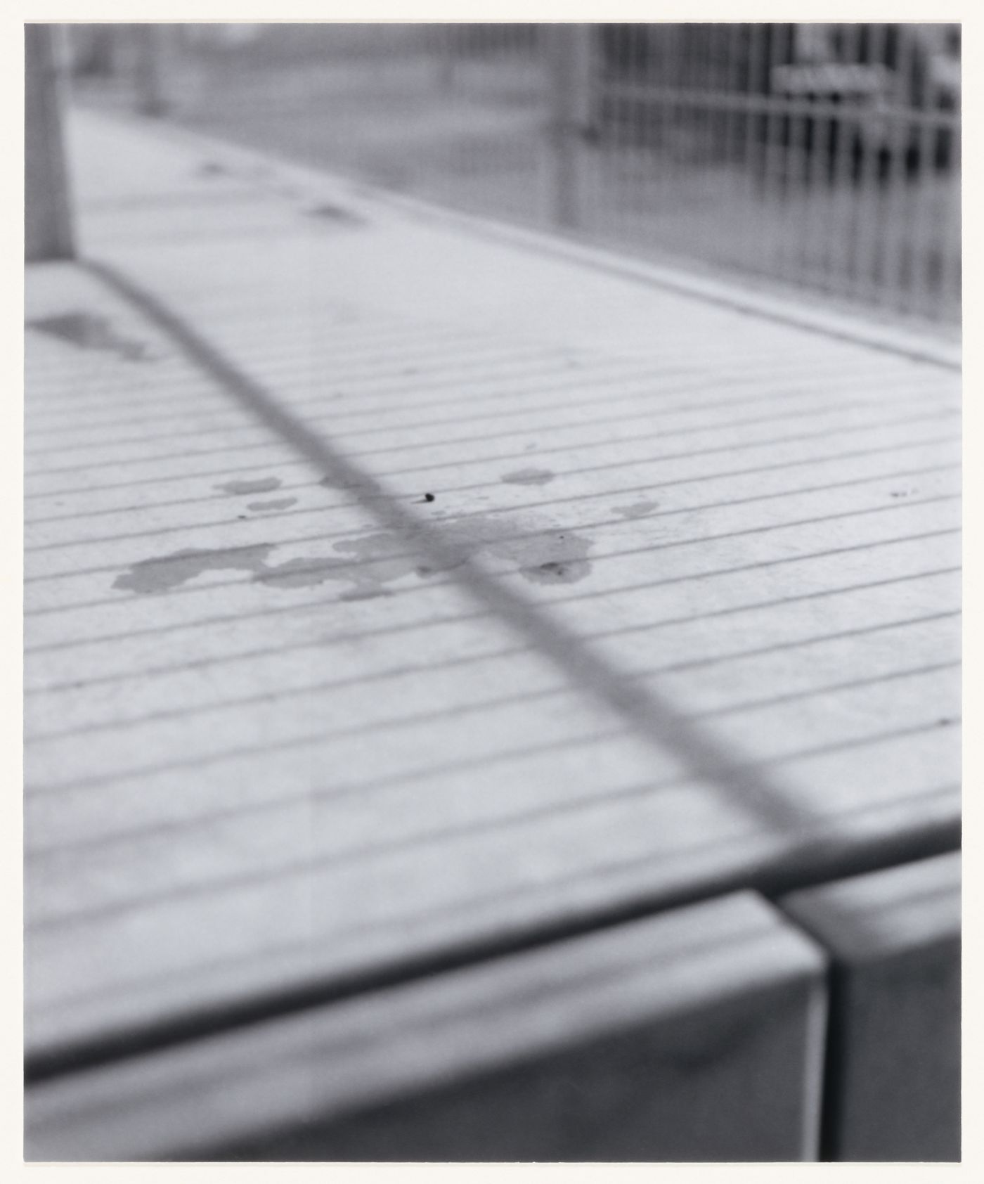 View of a boardwalk, cast shadows and a metal fence, Berlin, Germany, from the artist book "The Potsdamer Project"