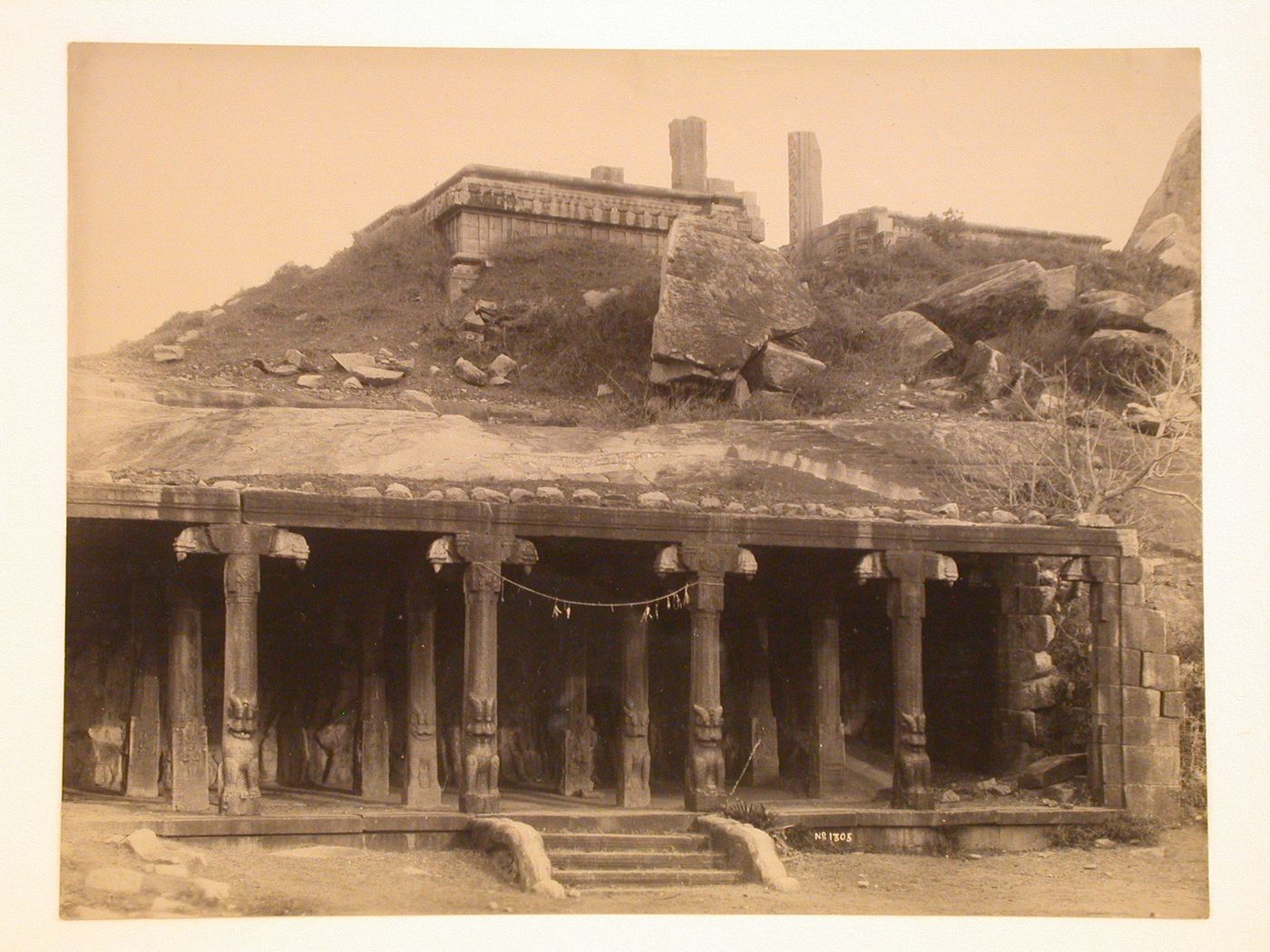 View of a columned entrance to a temple or a hypostyle hall, also showing ruins of a temple above, India