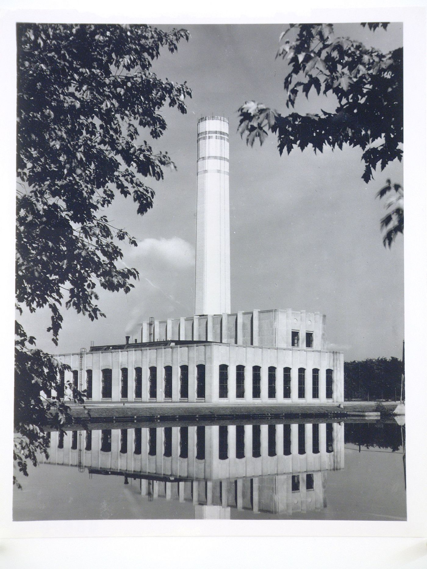 View of the principal and lateral façades of the Power House for the Engineering Laboratory from across a river [?], Rouge River Plant, Ford Motor Company, Dearborn, Michigan